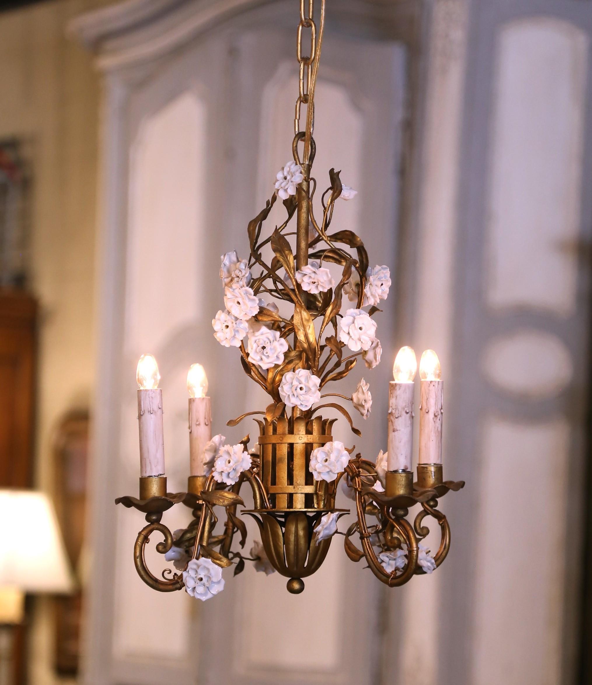 Hang this delicate floral light fixture in a girl’s bedroom or a powder room for a charming, feminine decor accessory. Crafted in France circa 1920, and round in shape, the petite antique chandelier is decorated with porcelain flowers in a white