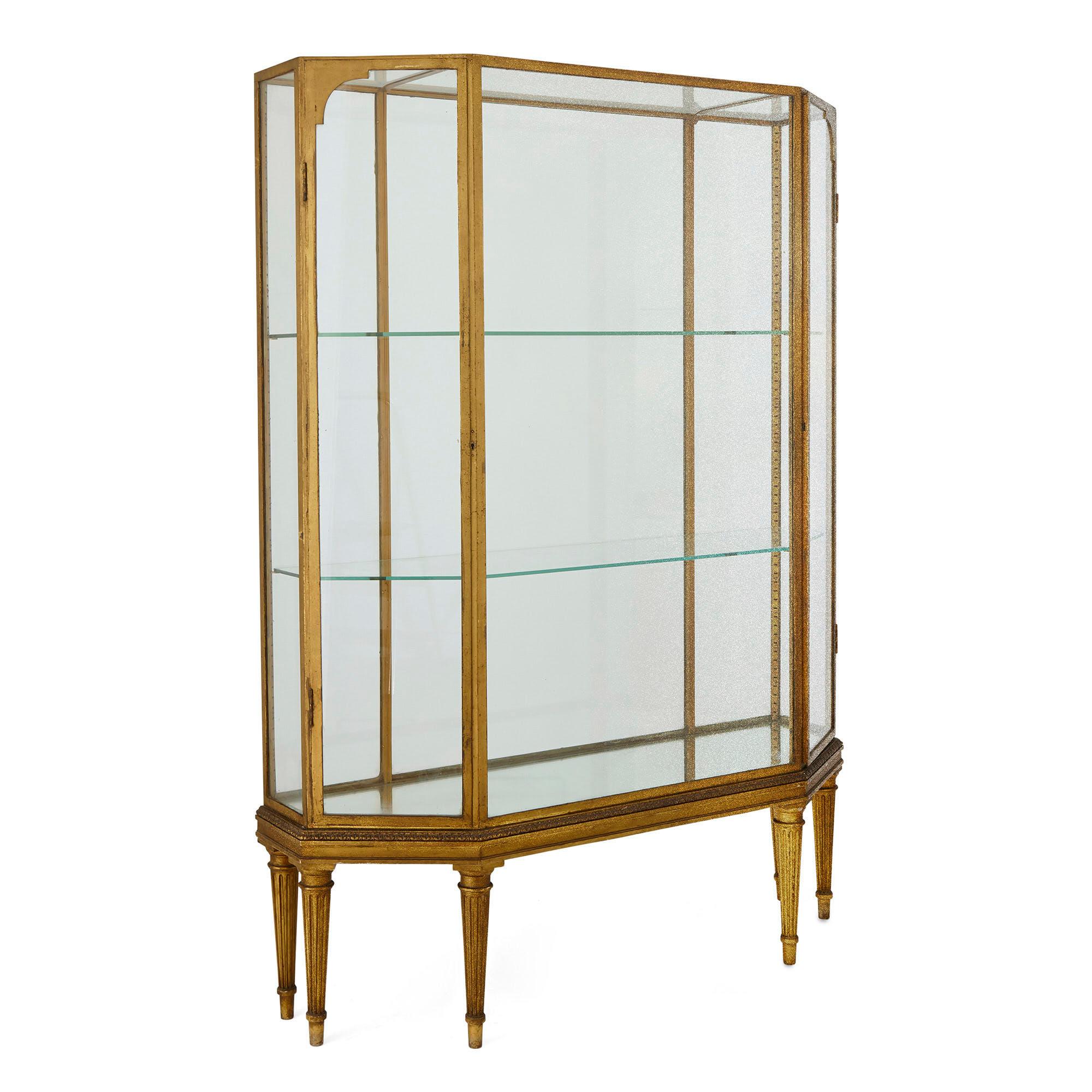 Early 20th century French giltwood display cabinet
French, early 20th century
Measures: Height 175cm, width 130cm, depth 40cm

This beautiful early 20th Century display cabinet is wrought from giltwood, gilt-metal, glass, and mirror. The cabinet