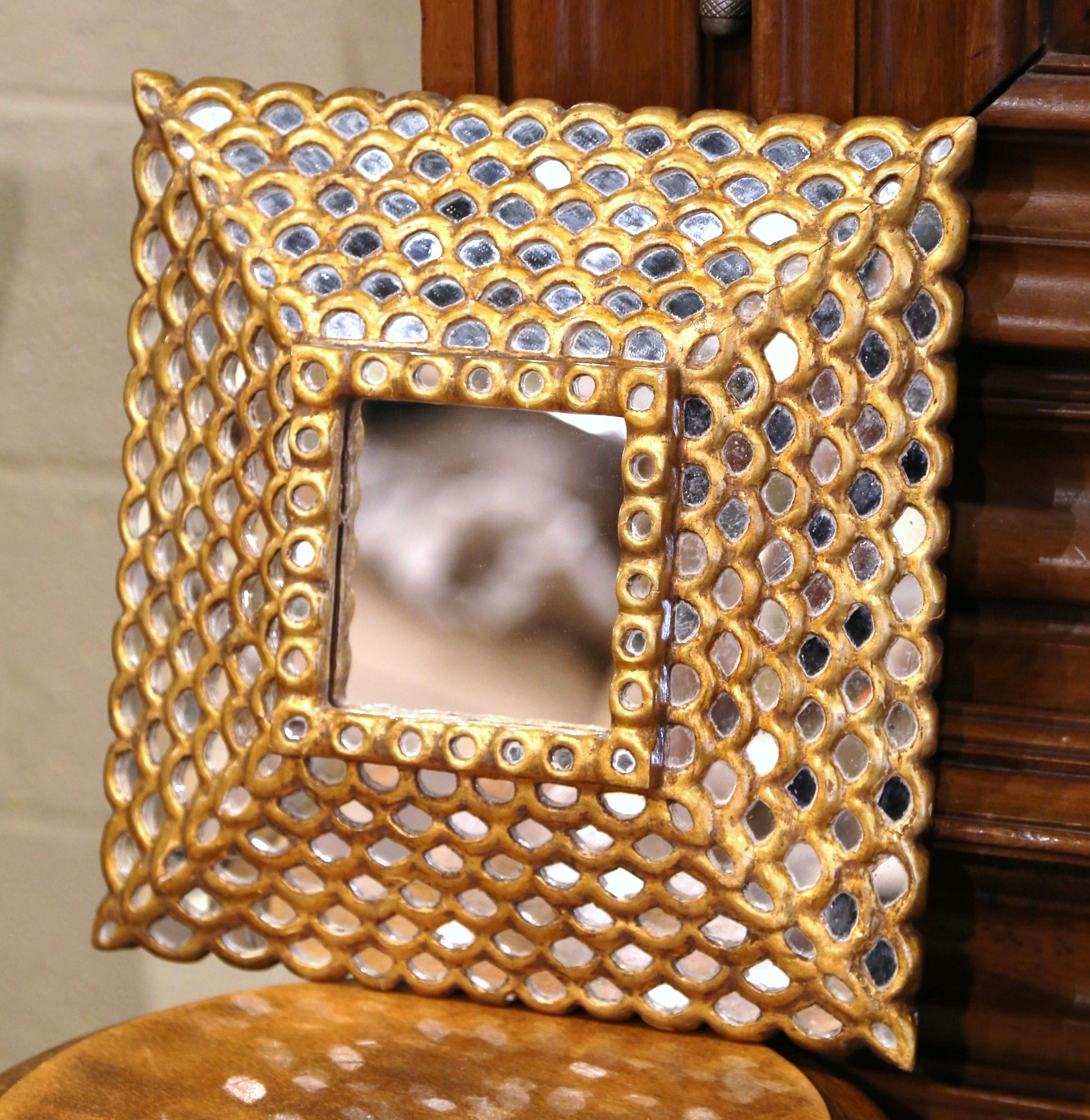 This elegant vintage sun mirror was crafted in France, circa 1930. Square in shape the antique wall mirror features a raised square center mercury glass set inside a carved frame; the four sides are decorated with small overlay mirrored insets. The