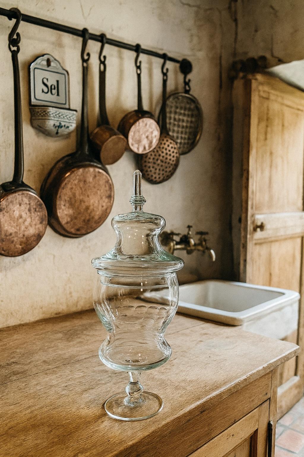Beau drageoir en verre datant des années 1920, présentant une silhouette élégante et généreuse typique des pièces de confiserie de l'époque. Entièrement réalisée en verre soufflé, elle se distingue par son pied élancé, son couvercle finement