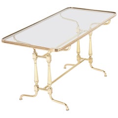 Table basse française du début du XXe siècle avec plateau en verre et laiton