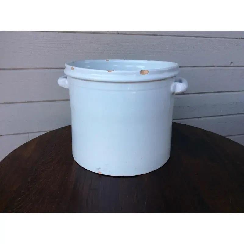 Found in Lyon, France this glazed terracotta French pottery bowl was probably used in the kitchen. The piece features two handles for easy mobility and is substantial enough for a potted plant. A perfect piece for the kitchen, bath or living area to