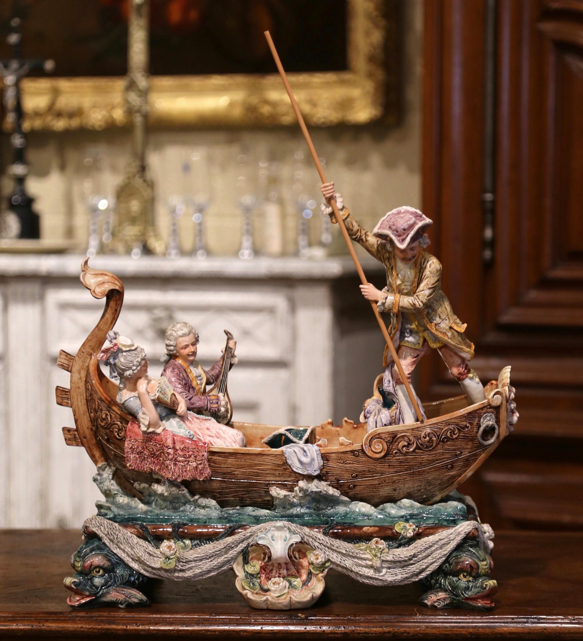 Bring this vibrant antique porcelain piece into your living room, office, or bedroom for a unique flair. This colorful, extremely detailed majolica figurine composition was created in France, circa 1880; it features a beautiful boat cresting small