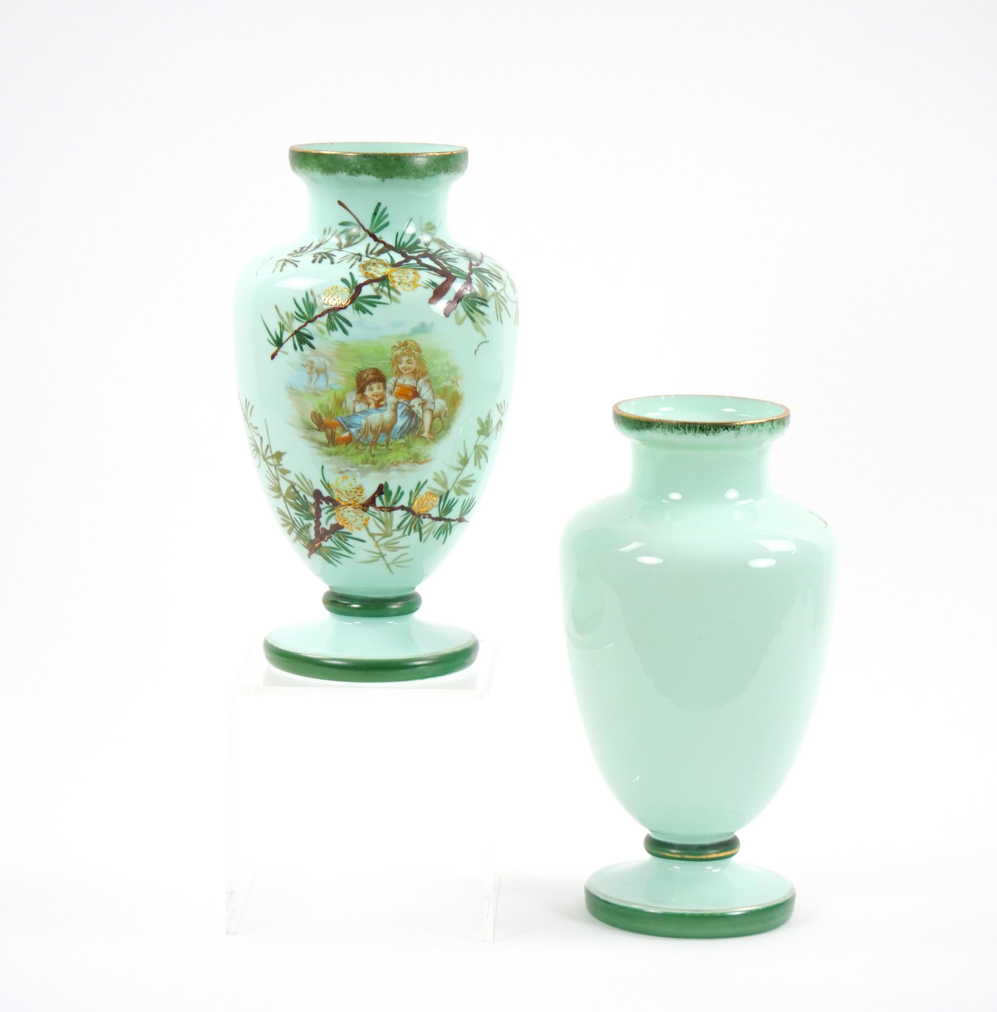 
Transport yourself to the early 20th century with these exquisite French hand-painted art glass decorative vases. Adorned with captivating scenes, each vase tells a story of innocence and joy as children gather around a pinecone tree, engaged in