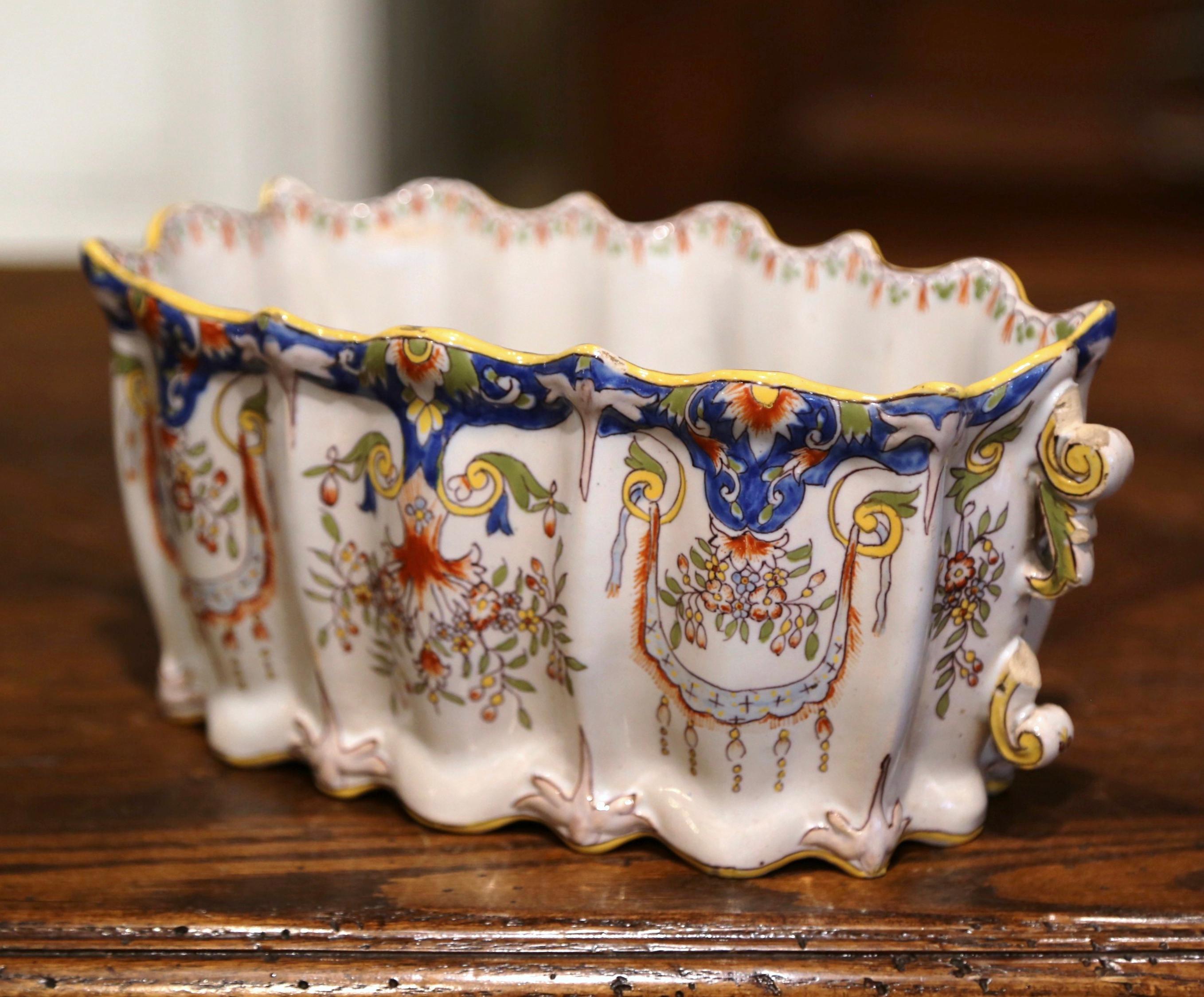 Decorate a mantle, table or buffet with this colorful antique planter. Sculpted in Normandy, France circa 1920, and rectangular in shape, the ceramic jardiniere is dressed with side handles over a scalloped rim at the top, and a scalloped apron at