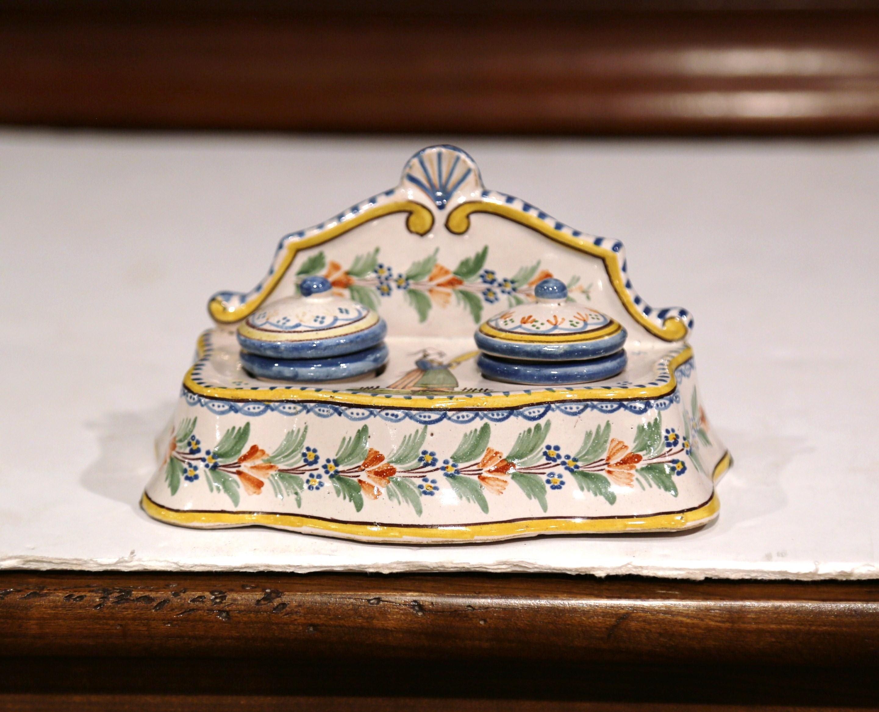 Decorate a lady's writing desk with this colorful antique inkwell from Brittany. Crafted in western France circa 1904-1922, the elegant piece has its original ink containers and matching lids. The porcelain piece is hand painted with a traditional