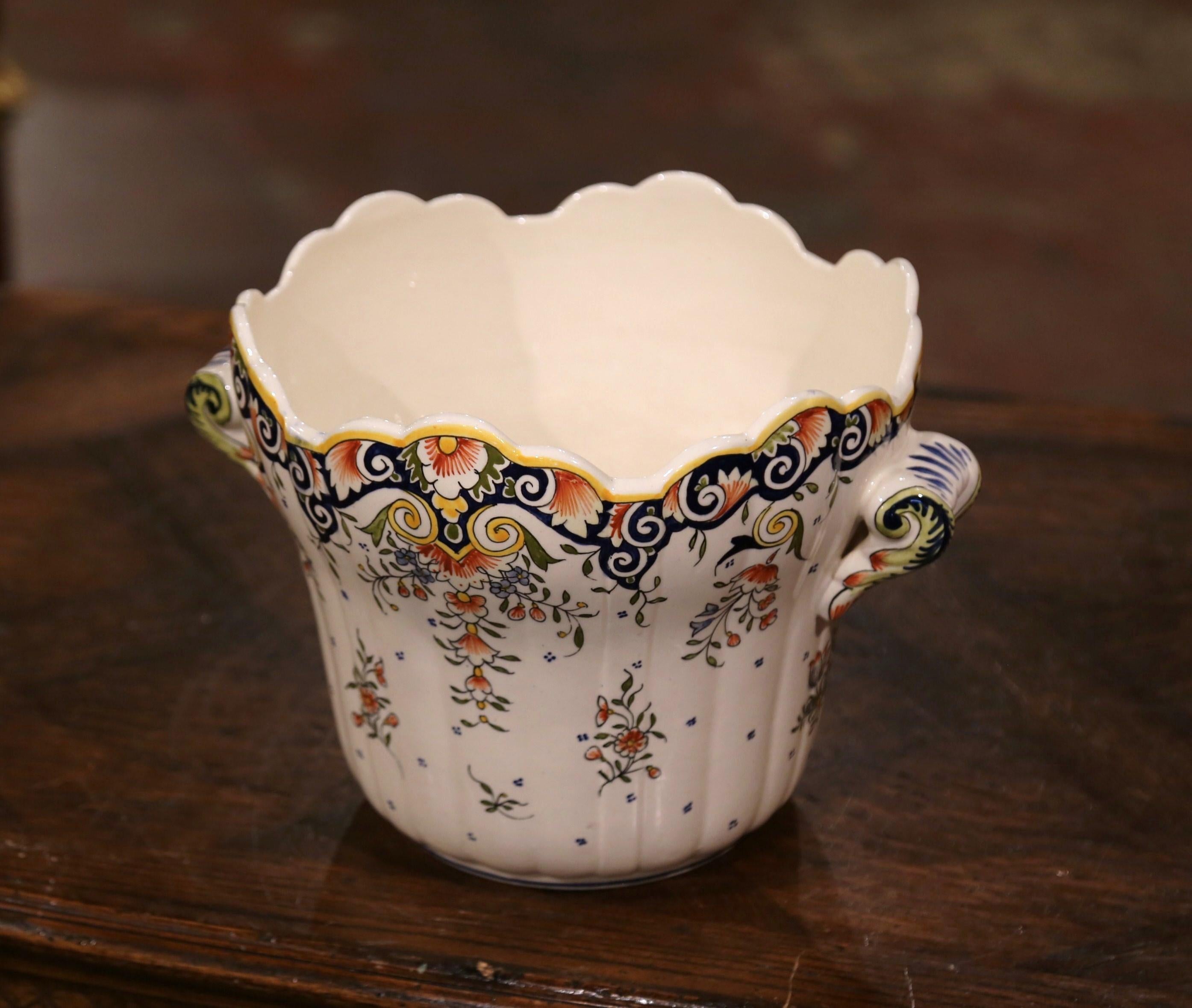 This planter would bring French elegance to any room of the house. This feminine, antique ceramic cachepot was crafted in Normandy, France, circa 1920. The classic, colorful jardinière features hand-painted floral decor in a traditional blue,