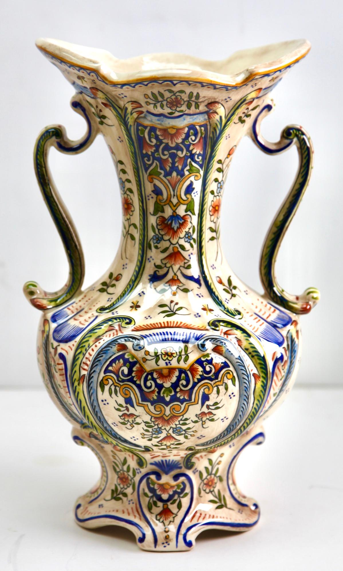 The designs on this French faience group is typical of pottery made in Rouen. 
Early 20th century French hand-painted Faience vasse from Rouen.
Marking on the bottom: 