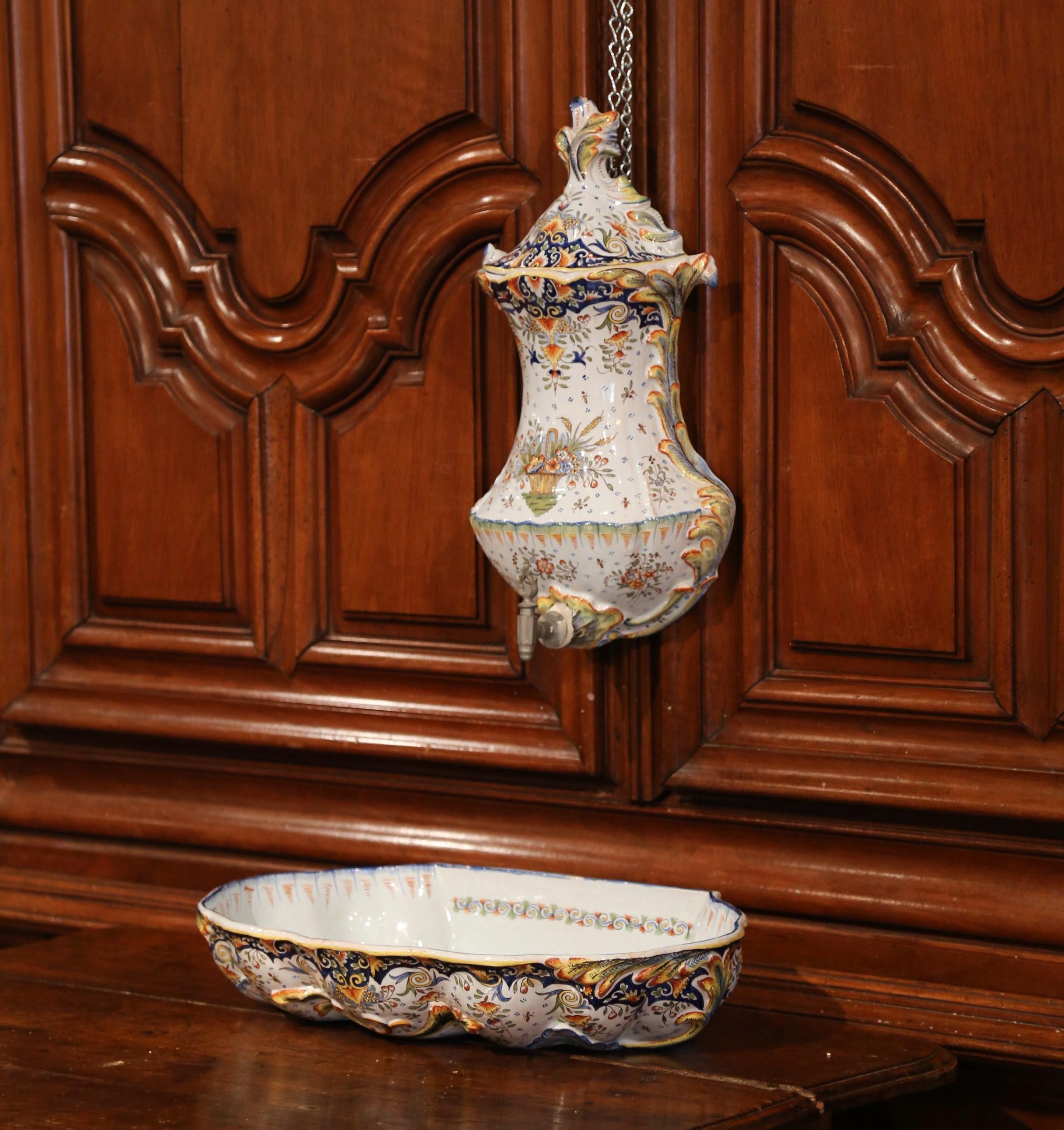 Decorate a wall with this antique ceramic fountain from Normandy. Crafted in Rouen, France, circa 1890, the decorative three-piece set is complete with basin, reservoir with metal spout, and lid. The faience lavabo, shaped as a shell, is hand