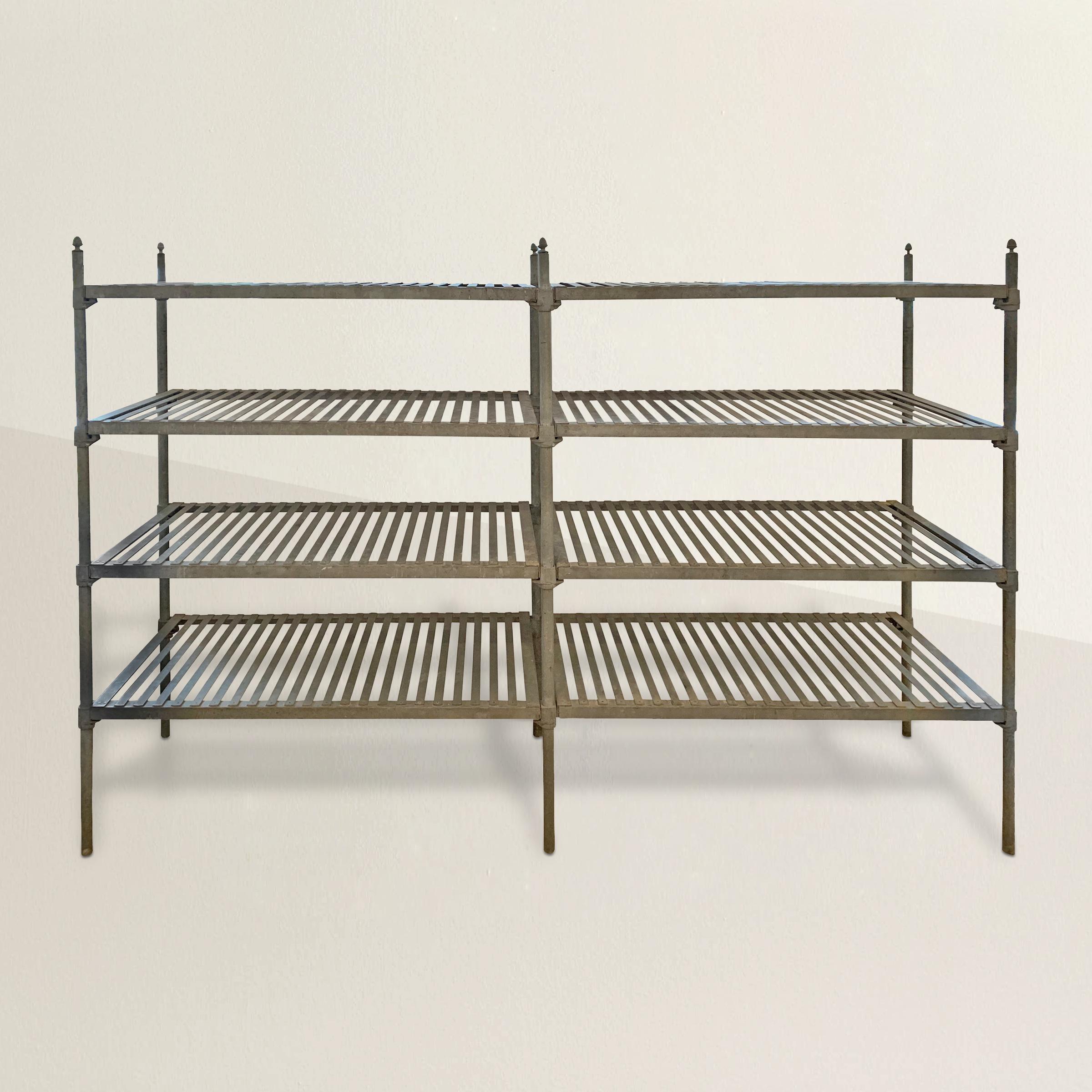 A simple yet chic early 20th century French industrial galvanized zinc shelving unit from a commercial kitchen or bakery with slatted shelves with uprights with whimsical acorn finials. The unit comes apart completely, and can even be configured for