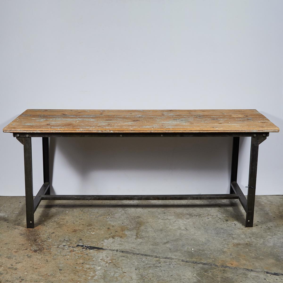 Early 20th-century French industrial table with blonde, exposed wood top and metal base. With its slim rectangular proportions and emphasis on raw materials, the piece has light but sturdy feel. 

France, circa 1900

Dimensions: 75W x 28.5D x 29.5H