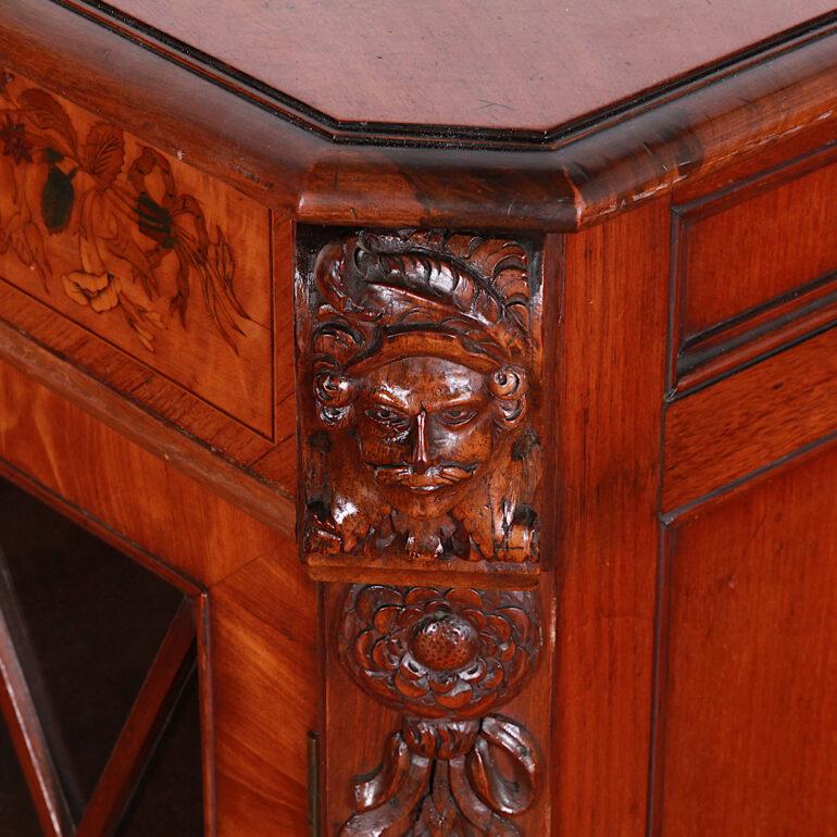 An early 20th century French inlaid walnut side cabinet with carved details to the canted corners and diamond glazing pattern.

 