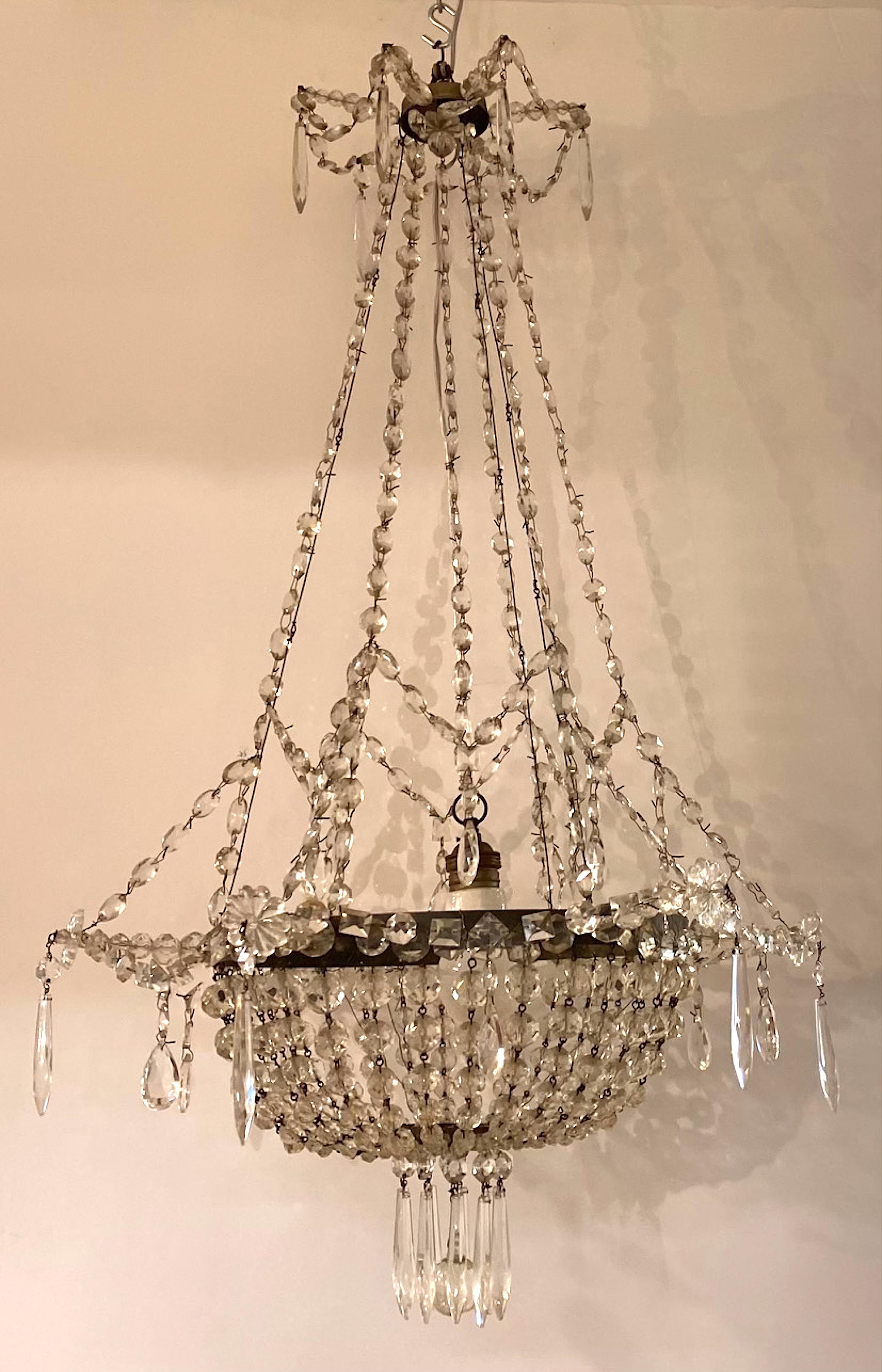 Early 20th Century ca. 1900 French Campaigne iron and crystal chandelier.
1 standart socket.