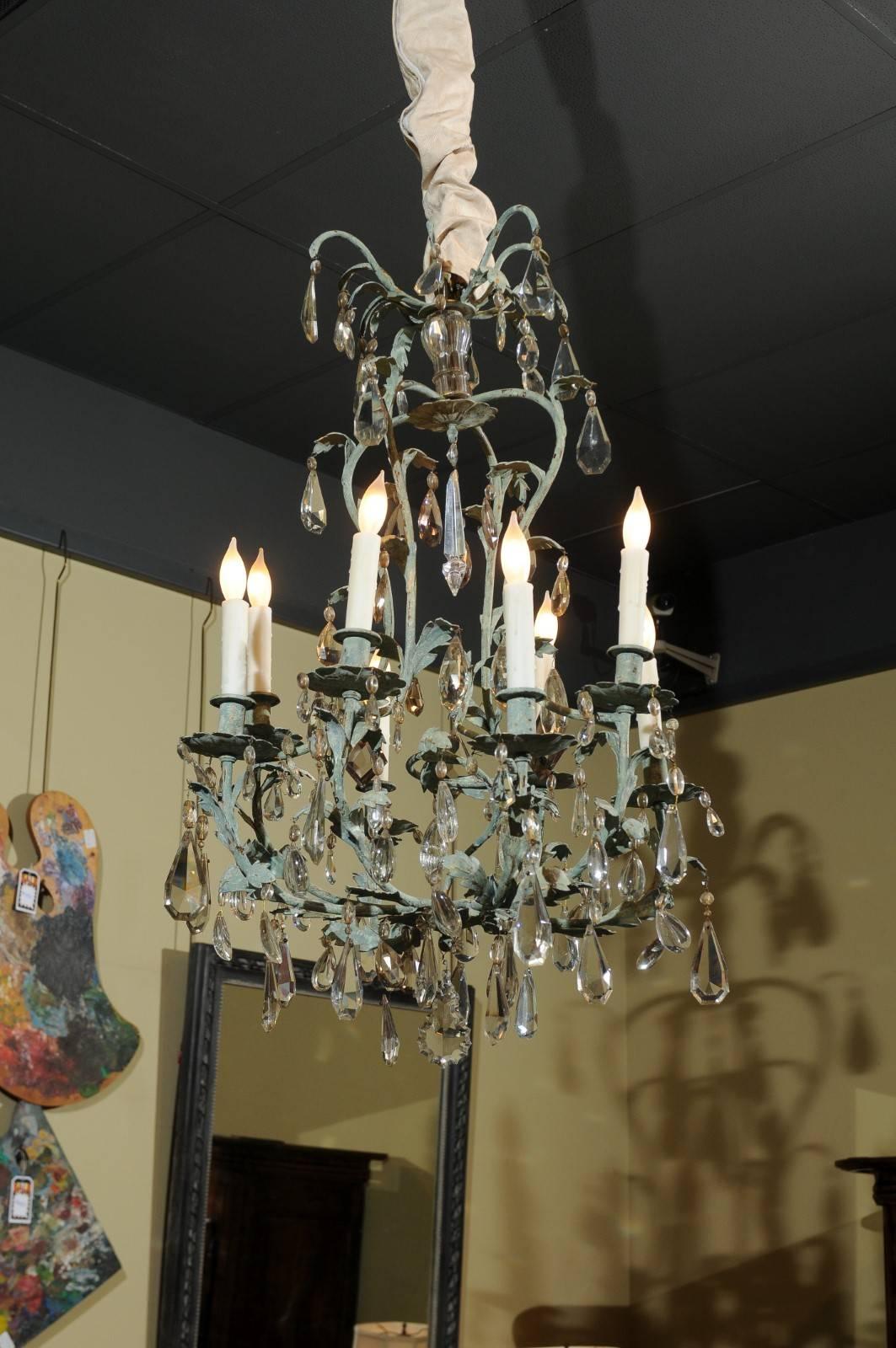 Early 20th century French iron and crystal chandelier, circa 1900
Both the tone of green and the wonderful shape on this chandelier gives this piece a light, fun feeling. The cage is basically a pear shape but with wonderful leaves intertwined on
