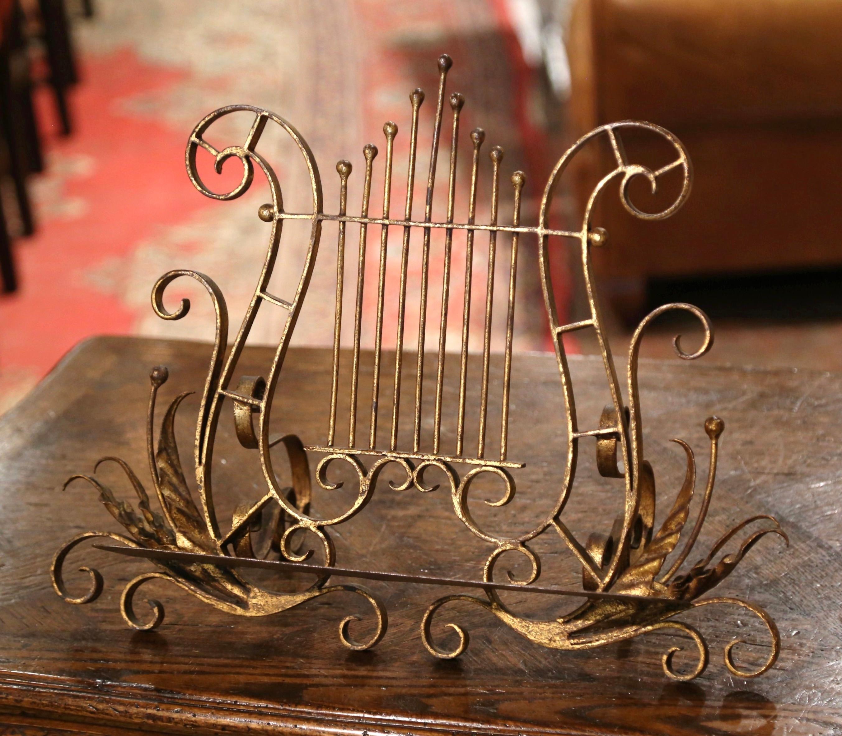 Display your Bible, music score or your favorite recipe book on this decorative, antique stand! Crafted in France circa 1920 and made of iron, the book holder sits on four small scroll feet decorated with acanthus leaf motifs. The stands features an