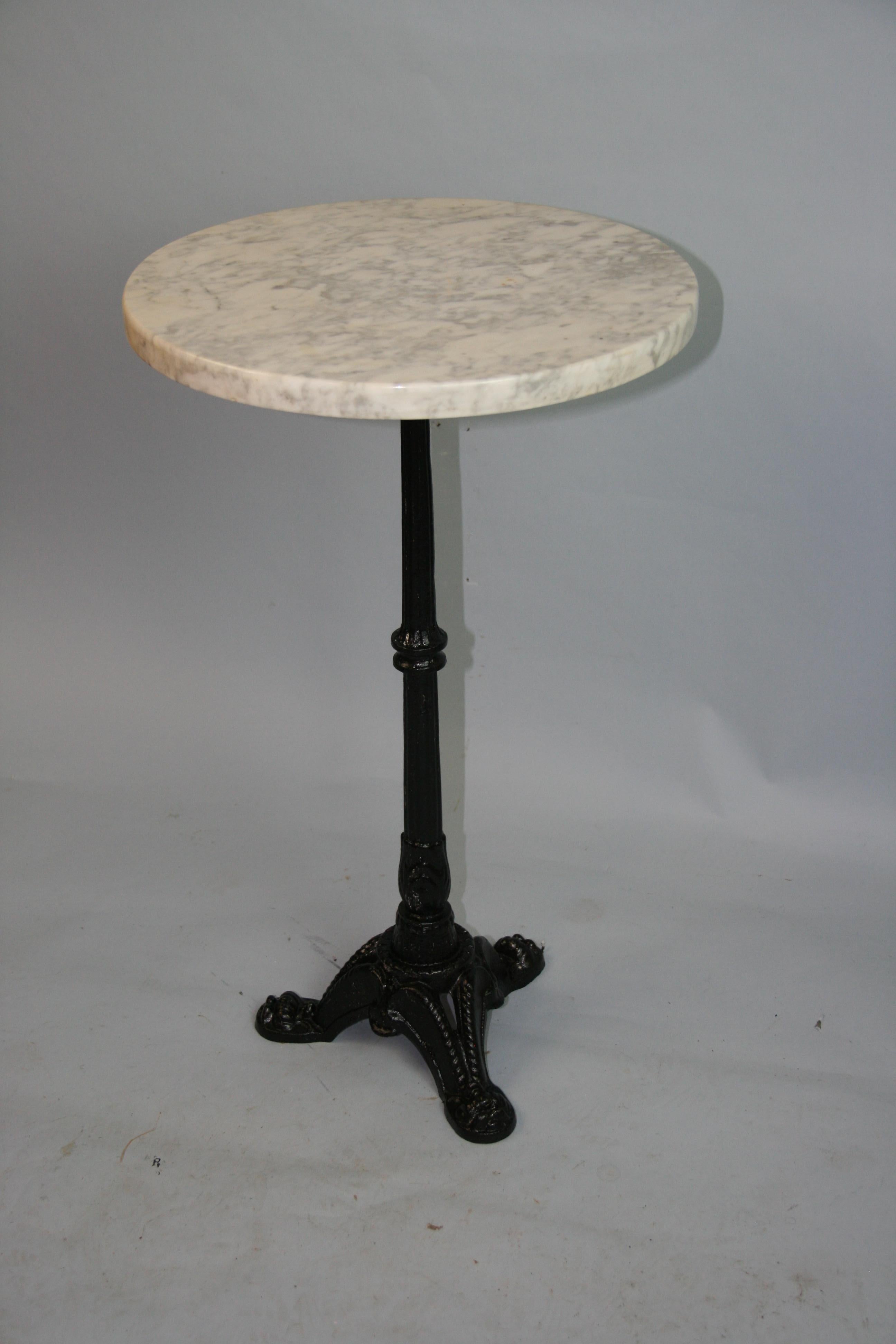 1293 This elegant antique round table was crafted in the south of France circa 1920.
The end table sits on three curved legs ending with paw feet under a tapered and fluted pedestal stem. Marble top is white and grey.