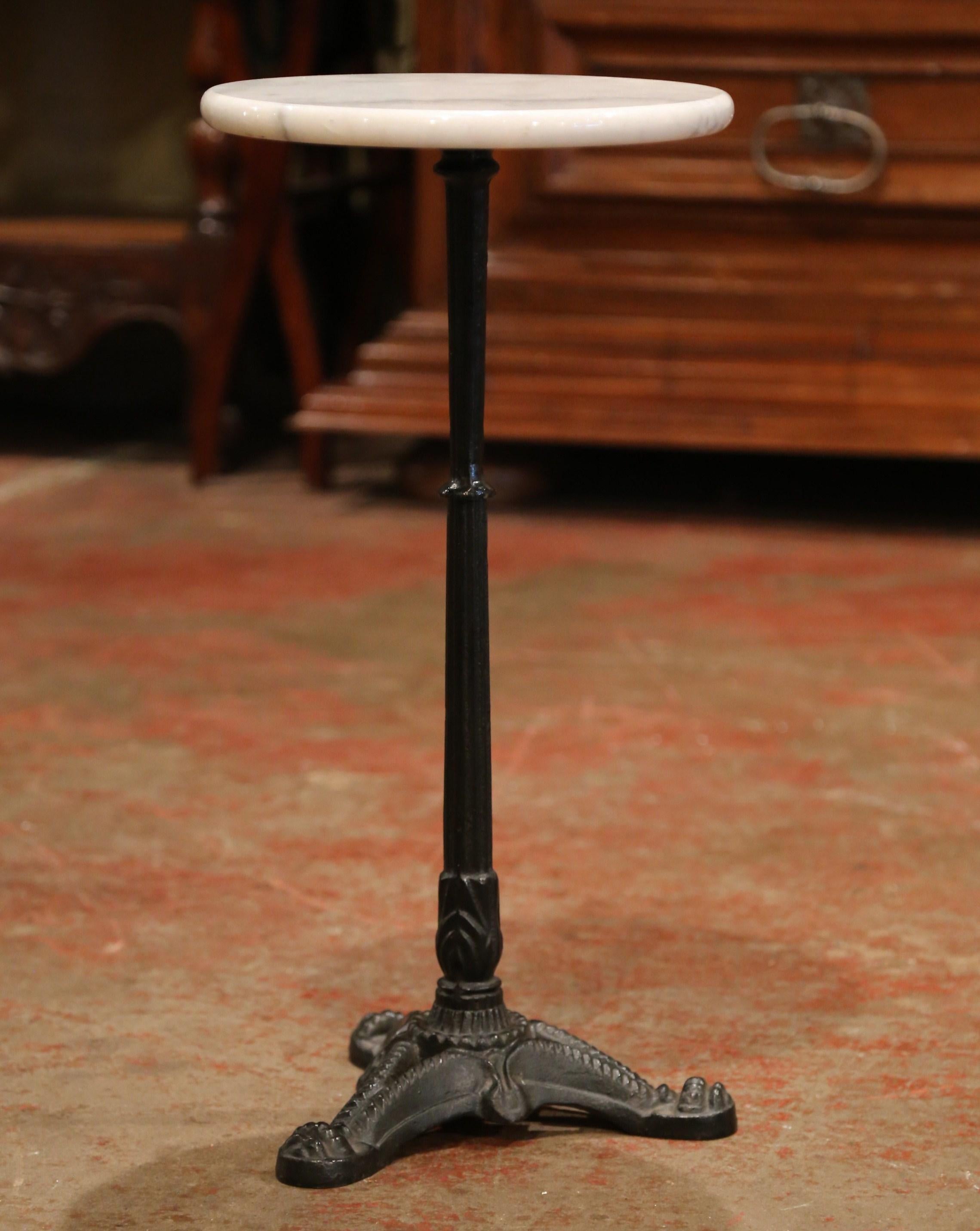 This elegant, antique round pedestal table was crafted in Southern France, circa 1920. With the original patinated black finish, the small end table sits on three curved feet under a tapered pedestal stem. The side table is topped with a white round