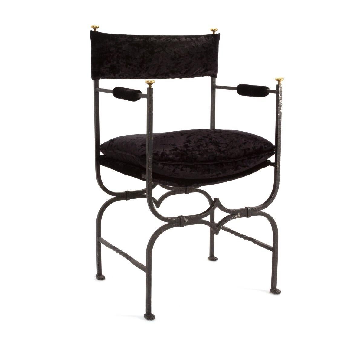 A vintage early 20th century iron and velvet upholstered hall armchair, France, circa 1920. A black iron frame complemented by brass accents with black velvet fabric.

Dimensions: 20 inches H x 35.5 inches L x 17.5 inches D.