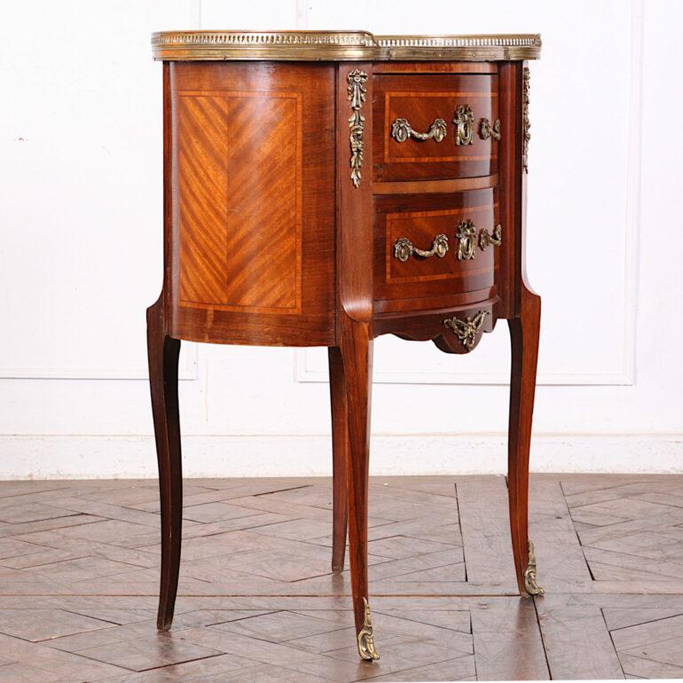 Small French kidney shaped two-drawer Louis XV style stand with inlay and faux-marble standing on fine elegant serpentine legs and with pierced brass gallery edge. C. 1930.



 