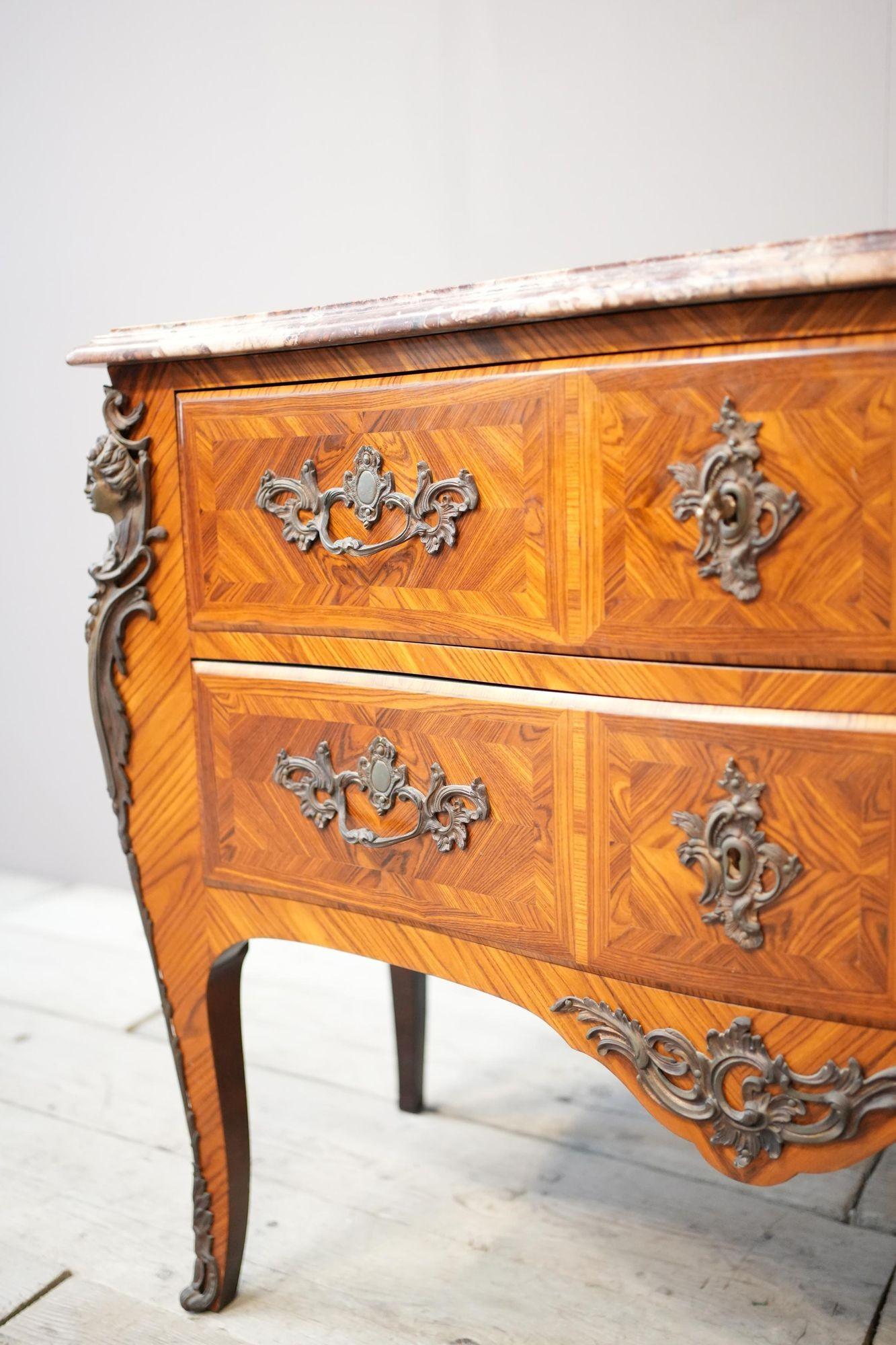 This is a truly exceptional French kingwood marquetry chest of drawers. Its quality is incredible as is its condition. Very clean and totally original. The bronze cast decoration is very fine and the red marble top sets the piece off perfectly. The