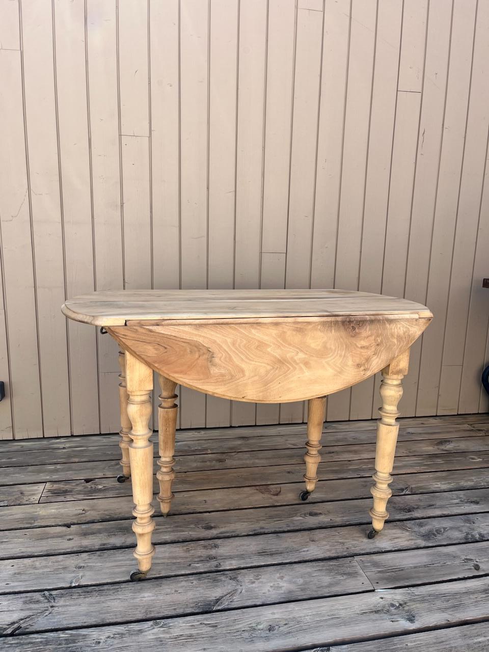 Get your hands on this beautiful antique table, recently sanded to reveal the natural beauty of its light wood.
Perfect for small spaces thanks to its drop-leaf system, it can expand to seat more guests or fold down to stay out of the