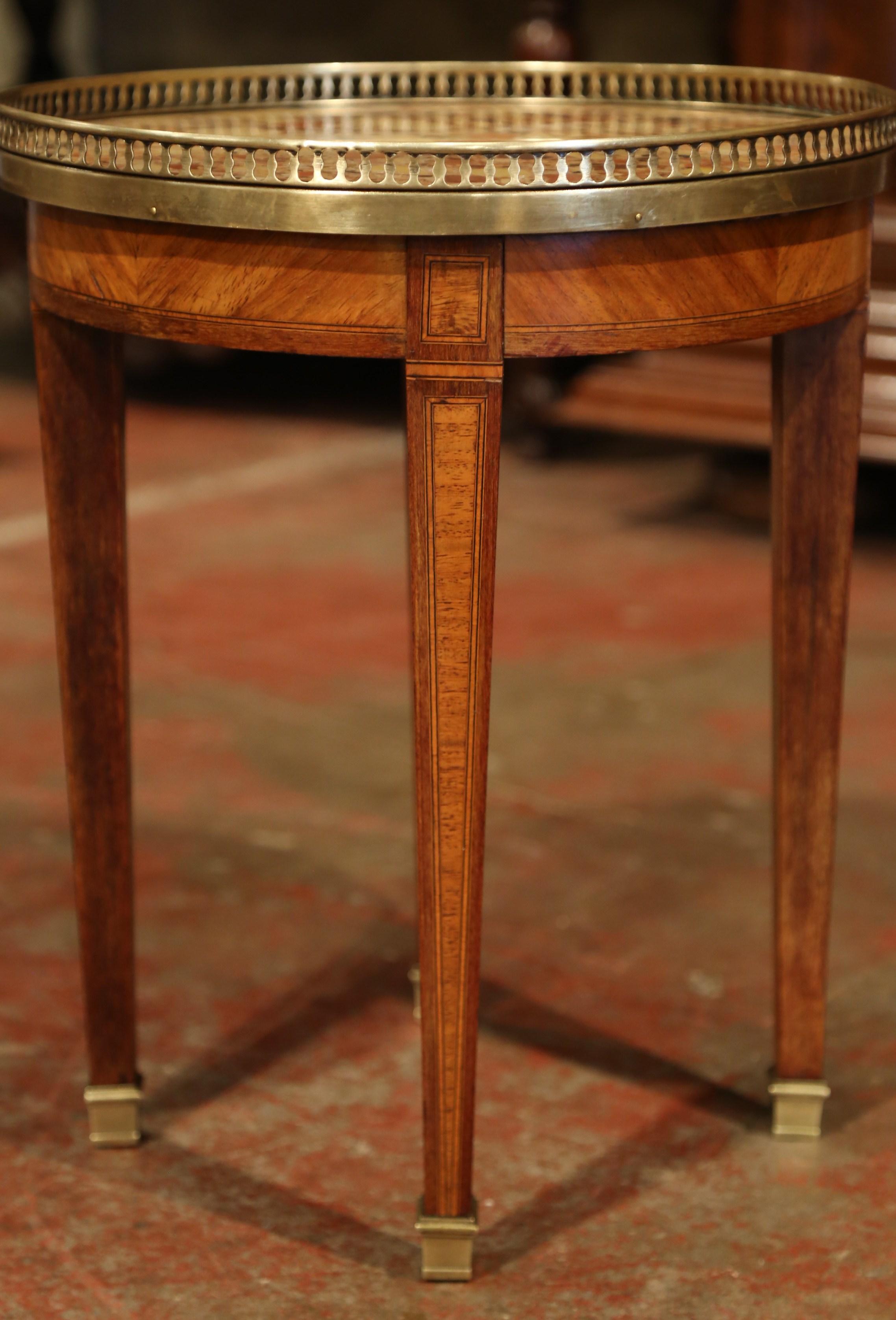 Place this elegant small table between a pair of chairs in your living room. Crafted in Paris circa 1920, the petite fruit wood martini table sits on four tapered legs with bronze sabots feet at the base. Both legs and apron feature detailed