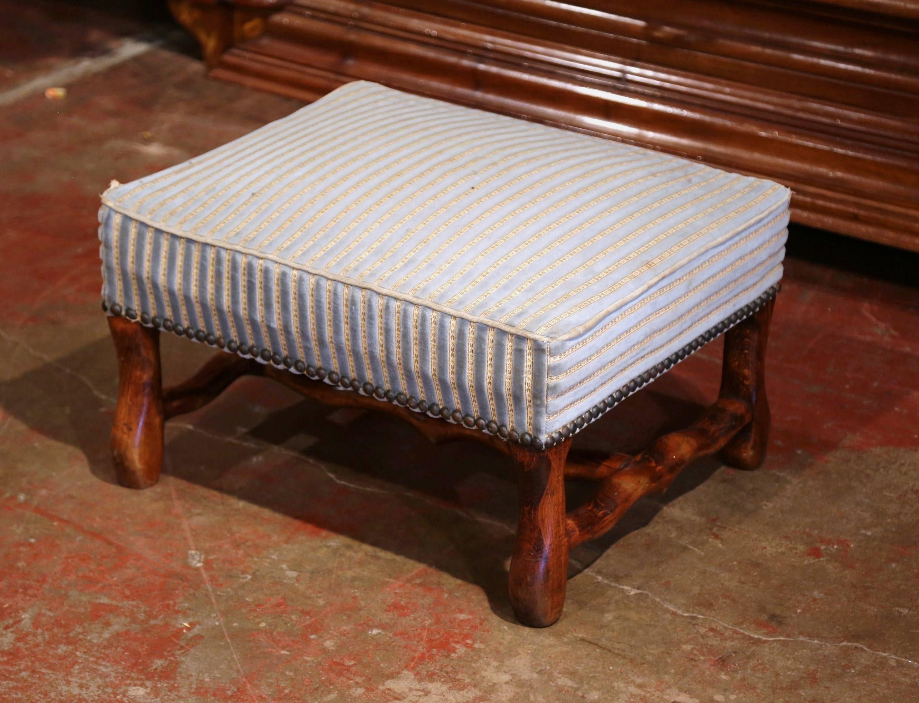 This elegant, antique ottoman was crafted in Southern France, circa 1920. The large foot stool stands on four carved 