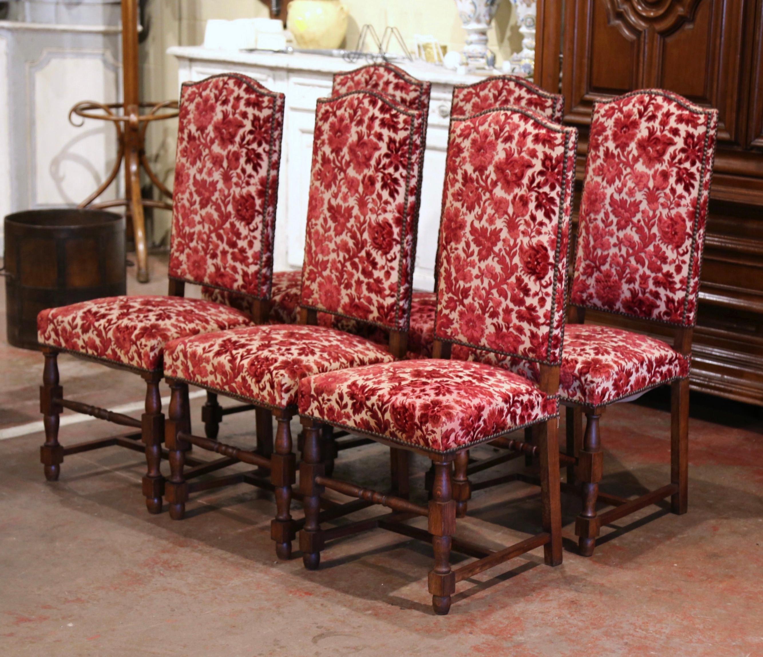 Place this elegant suite of six side chairs around your breakfast table for a true country French look. Crafted circa 1920 in the Louis XIII style, each chair stands on turned legs ending with bottom stretcher; the chair has a tall arched back and a