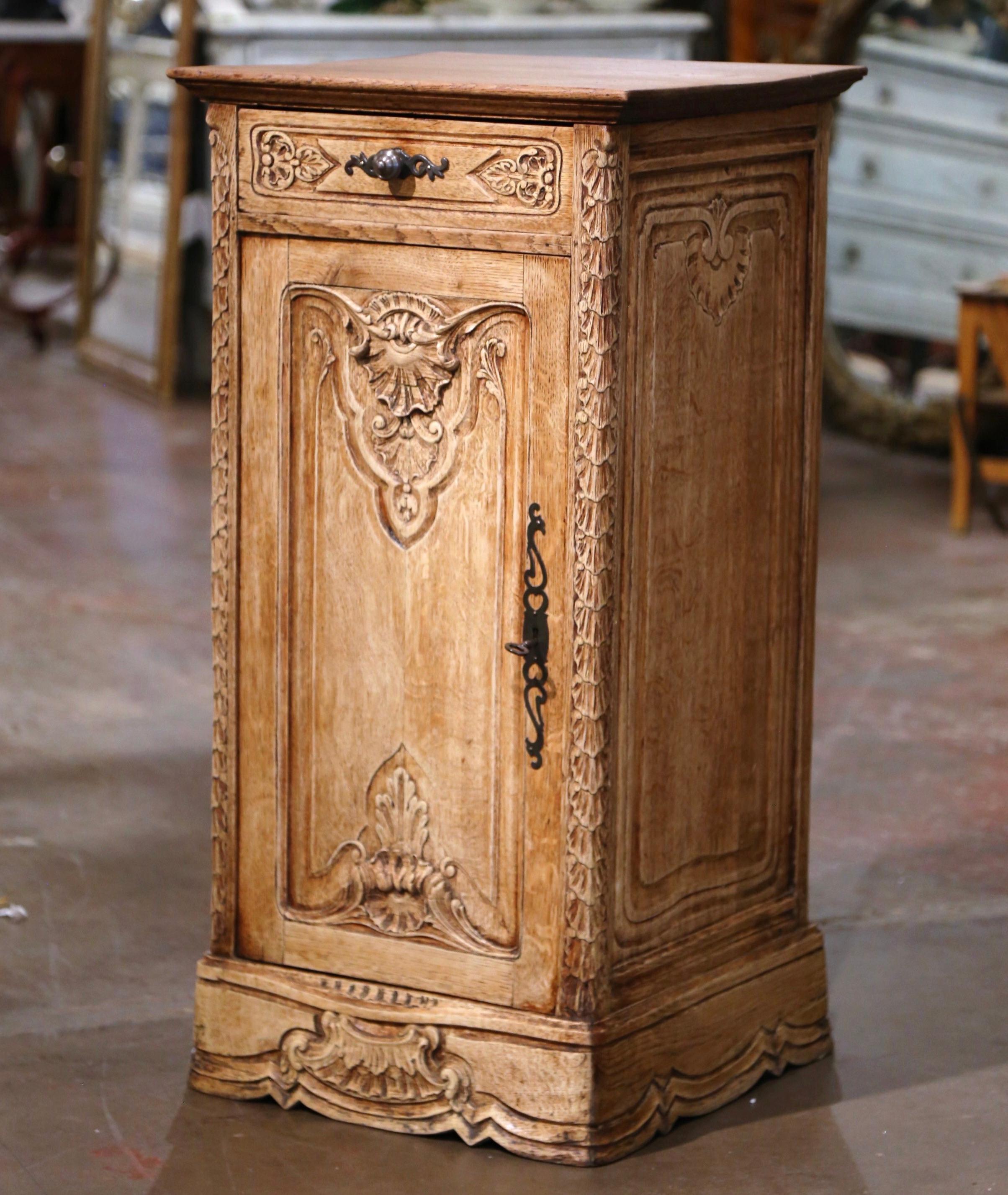 This elegant antique oak cabinet was crafted in Normandy, France circa 1920. The provincial 