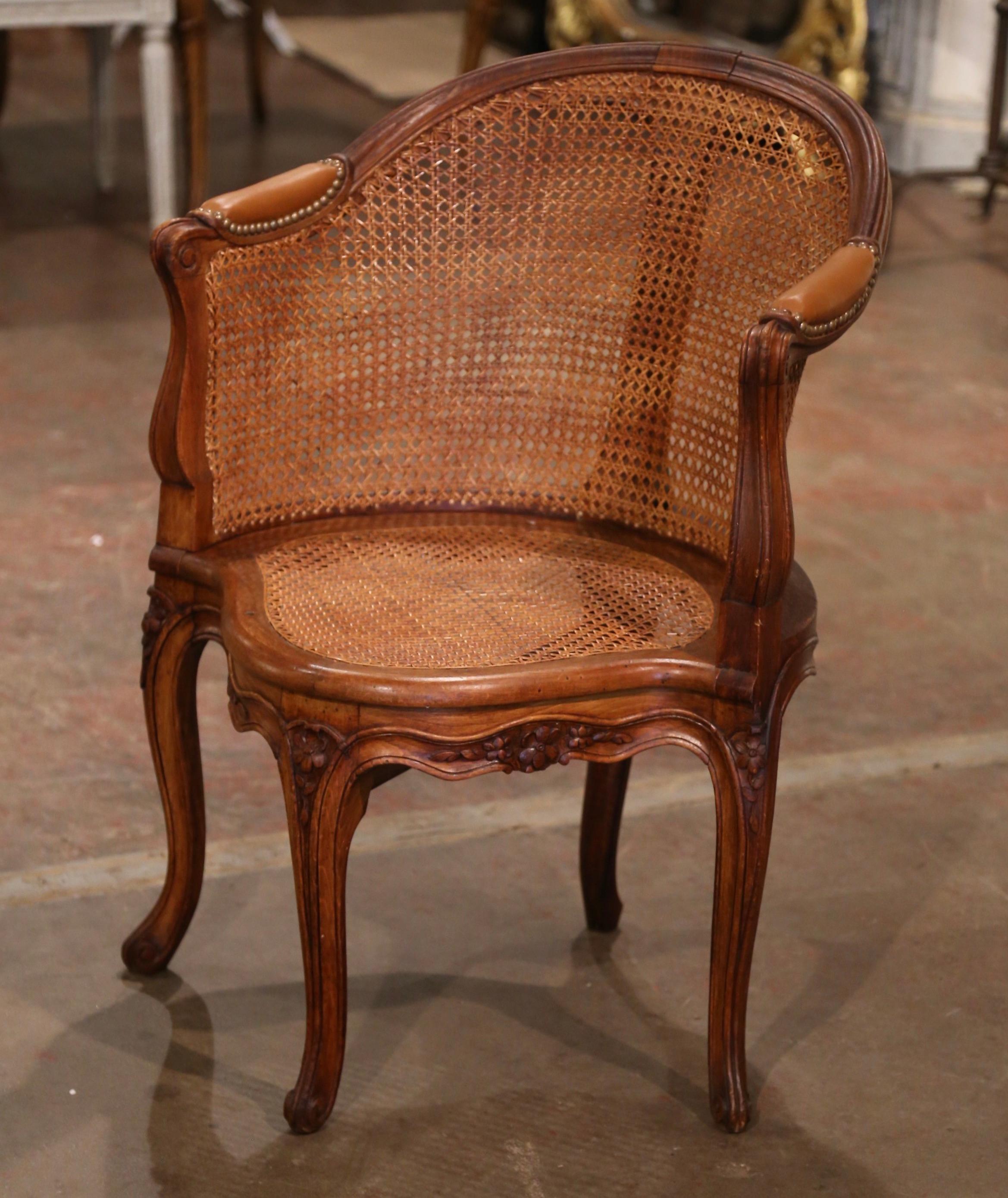 Decorate a study or office with this elegant antique armchair. Crafted in Provence, France, circa 1920, the corner desk chair stands on carved cabriole legs decorated with acanthus leaf motifs at the shoulders, and ending in escargot feet. The chair