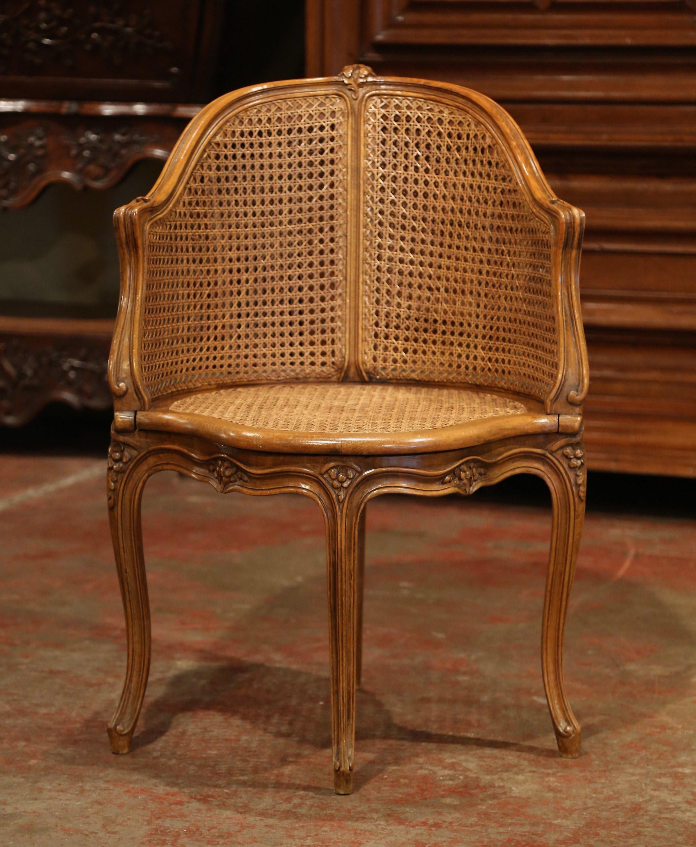 Decorate a study or office with this elegant antique desk armchair. Crafted in Provence, France, circa 1900, the corner chair has an arched and curved double-cane back. The desk chair stands on four carved cabriole legs over a scalloped apron