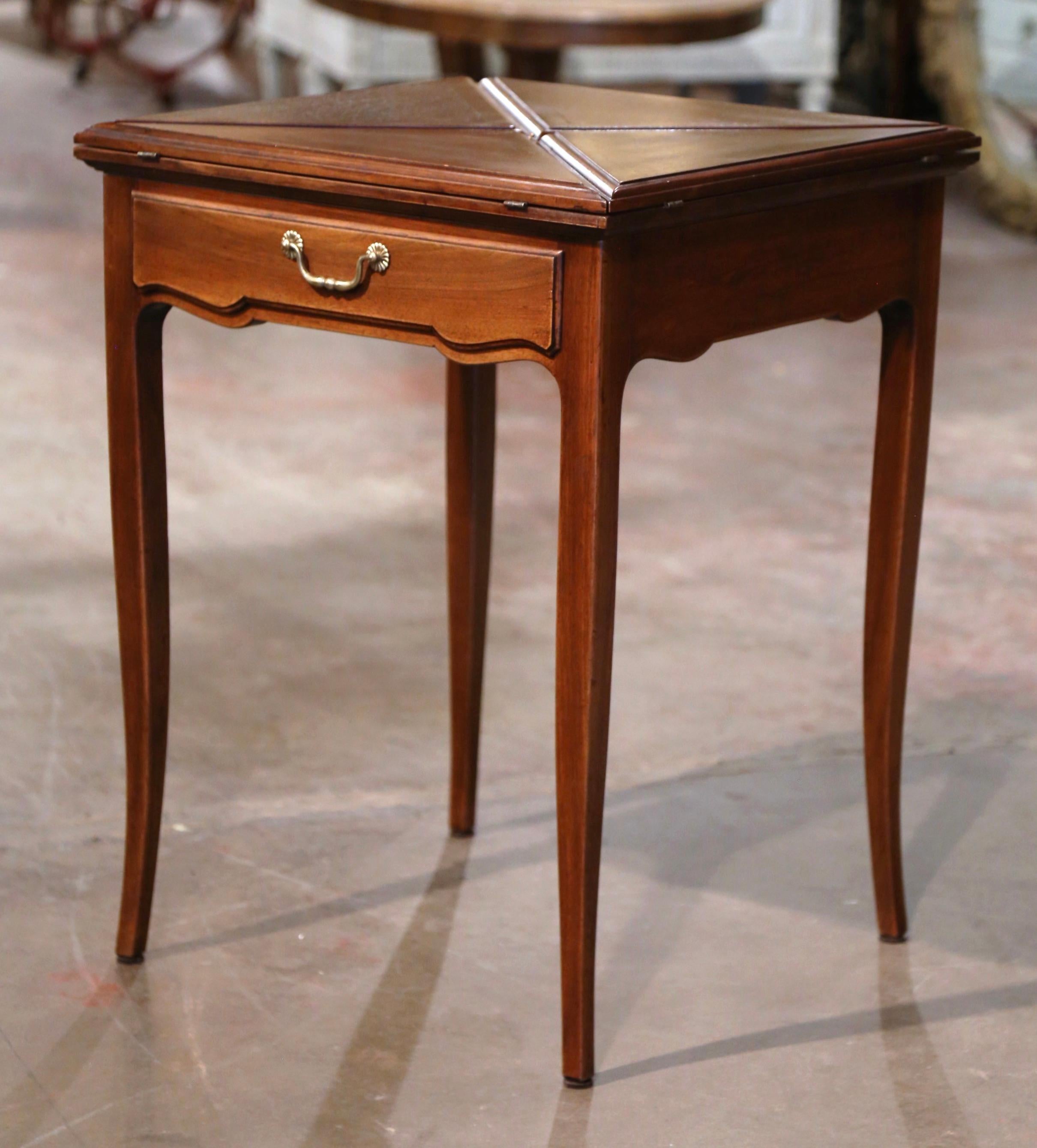 Decorate a game room or a den with this elegant folding card table. Crafted in France circa 1930 and built of mahogany wood with marquetry bands throughout, the square table stands on cabriole legs, over a scalloped apron dressed with a single