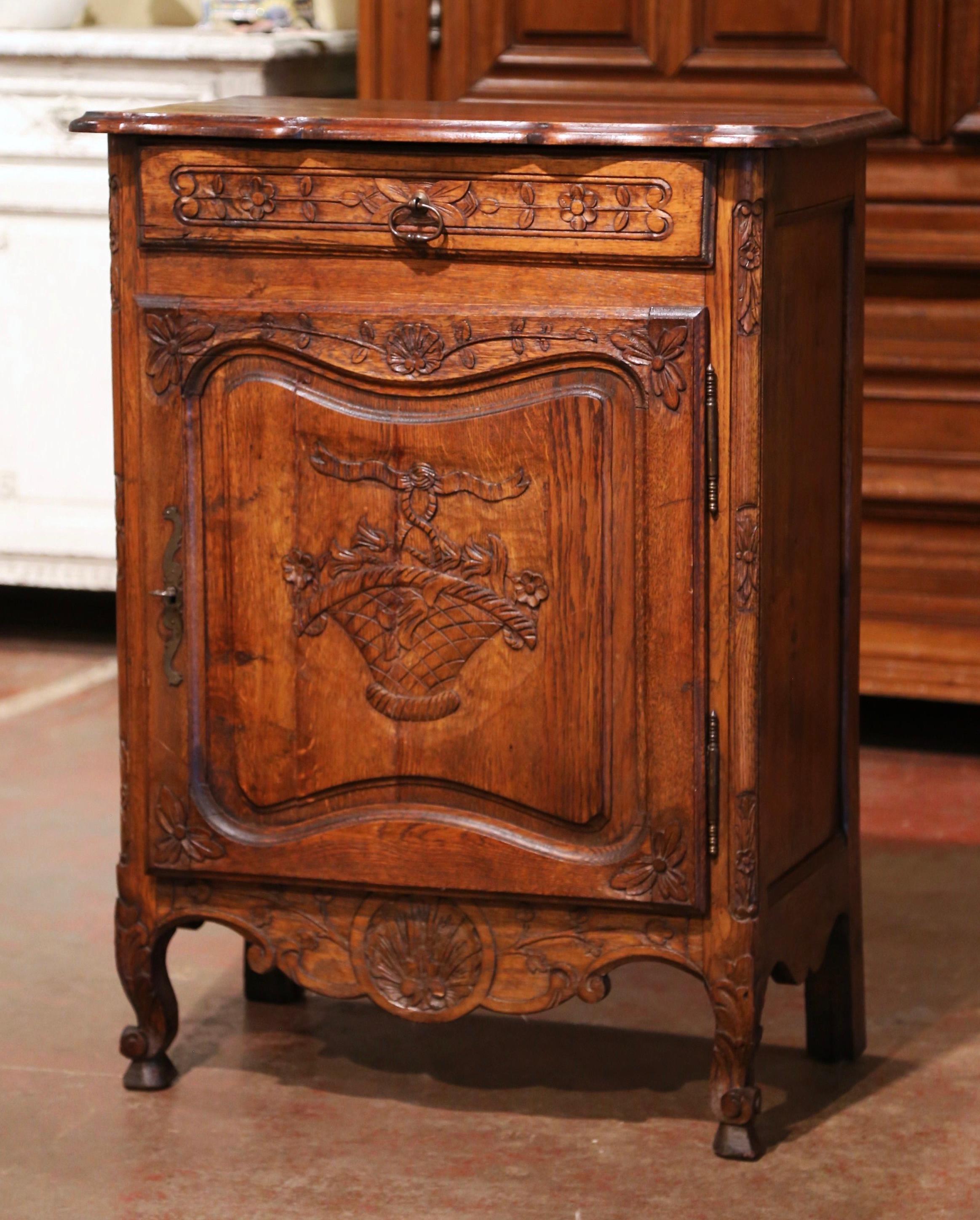 This antique jelly cabinet was crafted in Northern France, circa 1920. Standing on escargot feet decorated with acanthus leaves, the confiturier features a scalloped apron decorated with floral and shell motifs. The cabinet has a top drawer across