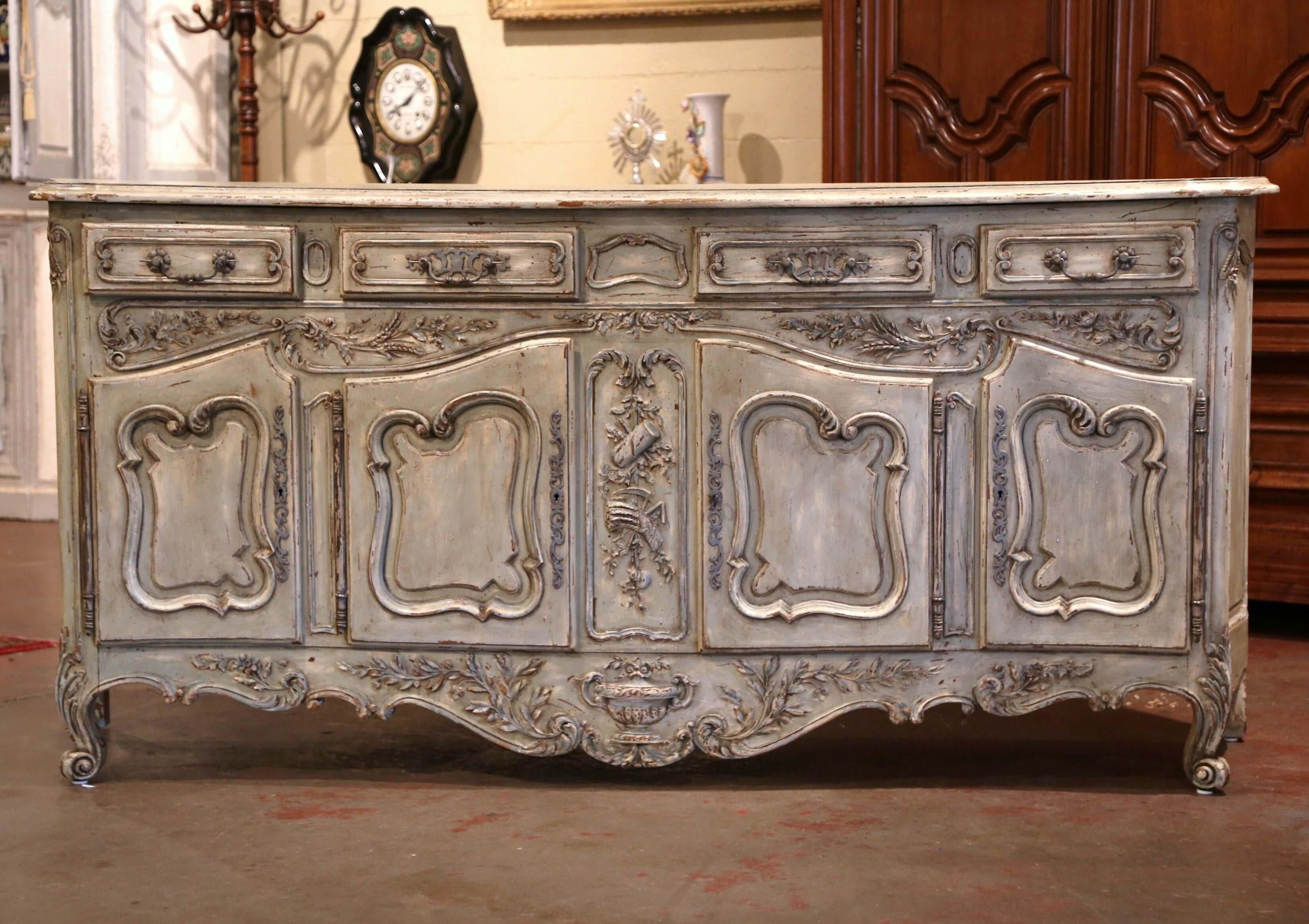 Beautiful and functional, this elegant antique enfilade from Southern France is not to be missed; crafted in Provence circa 1900, the buffet with bombe facade and curved sides, stands on escargot feet embellished with acanthus leaf decor. The