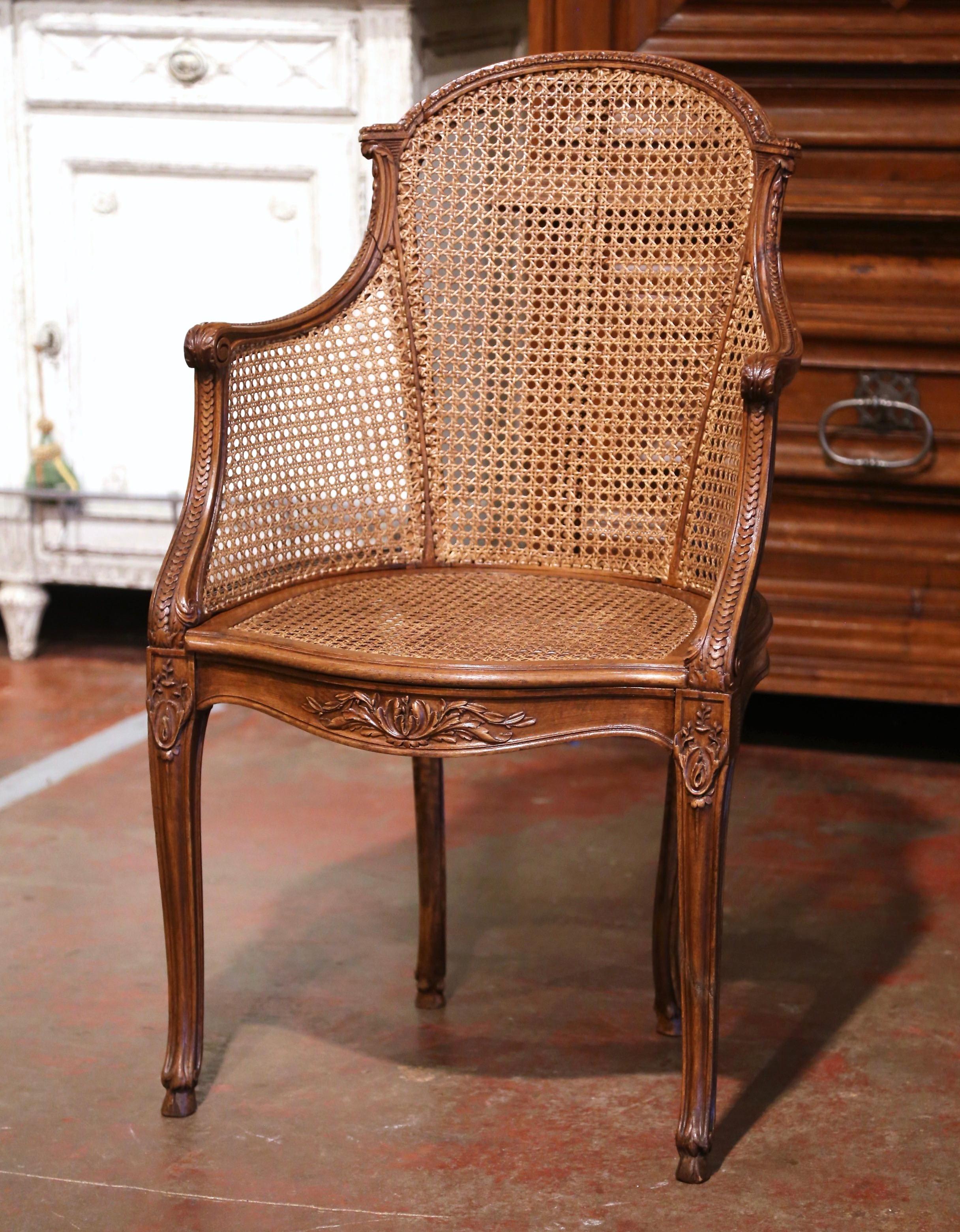 Decorate a study or office with this elegant antique desk armchair. Crafted in Provence, France, circa 1920, the chair stands on cabriole legs ending with escargot feet and decorated with carved floral motifs at the shoulder. The chair features an