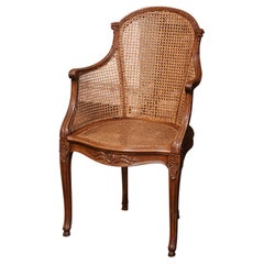 Early 20th Century French Louis XV Carved Walnut and Cane Desk Armchair