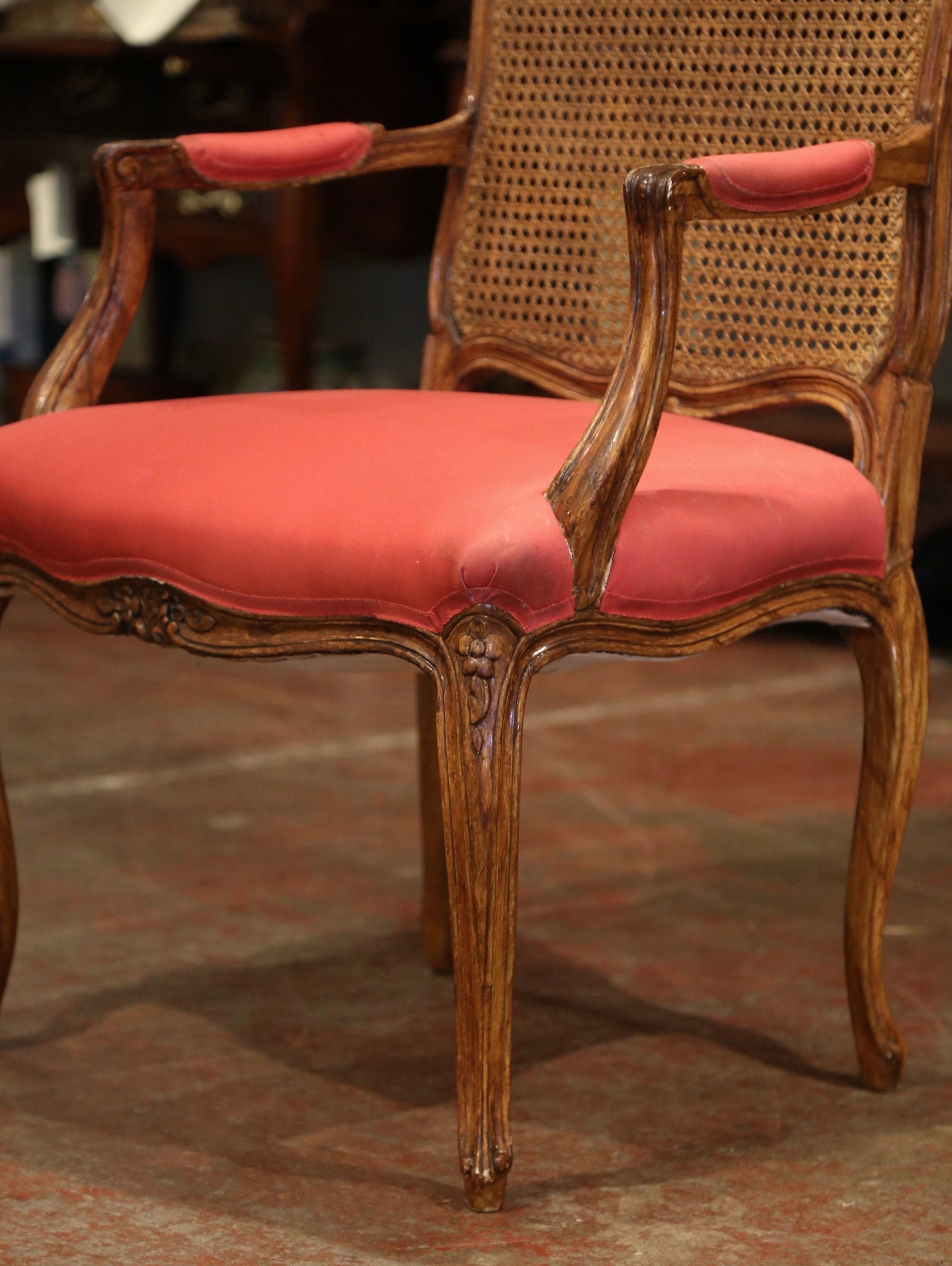 Add a pop of color to your office with this elegant, Louis XV style walnut armchair. Crafted in France circa 1920, the fruitwood Baroque desk chair sits on four cabriole legs, and has a scalloped apron decorated with carved foliage. The walnut chair