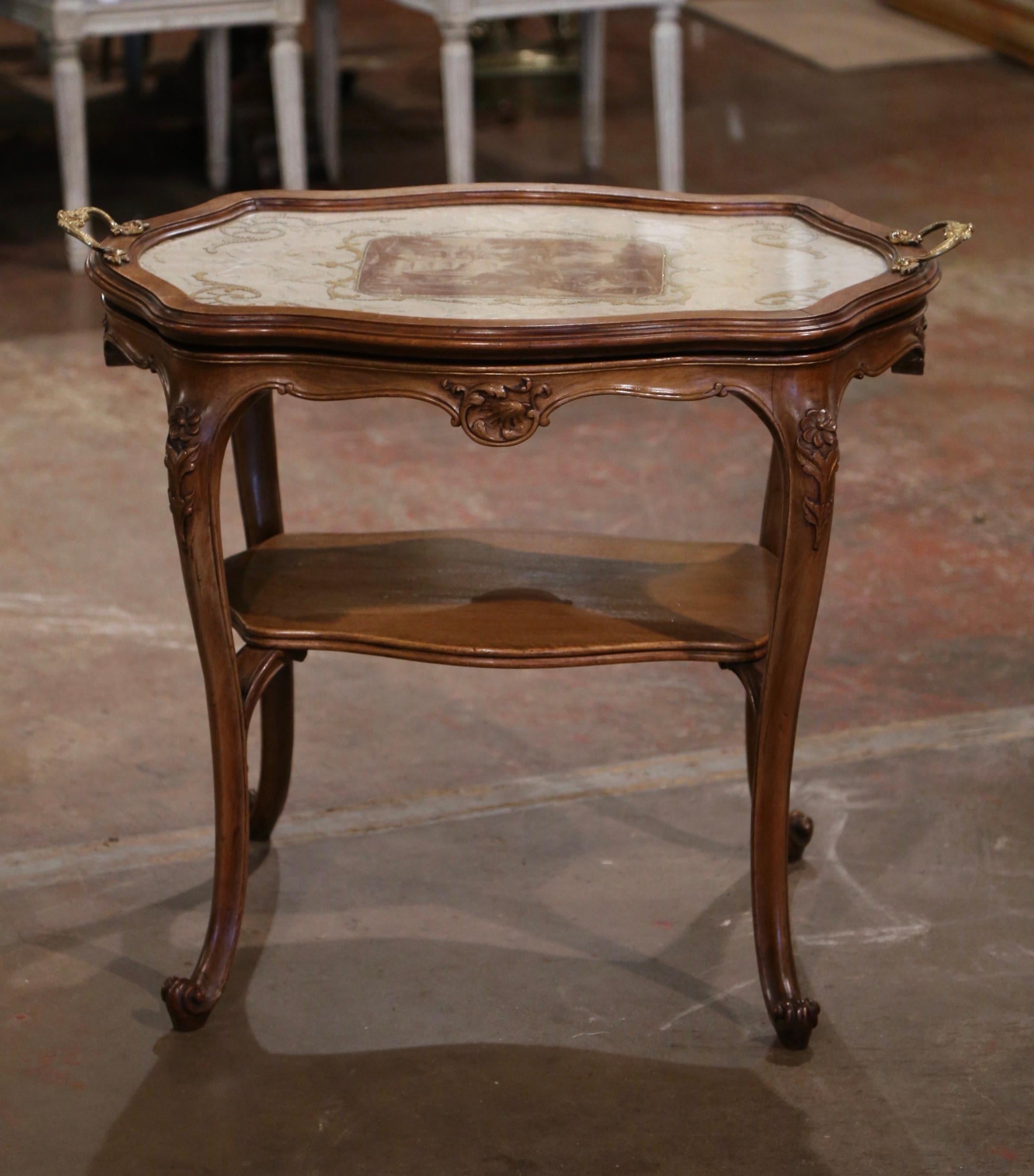 Use this elegant service table in your dining room to serve tea or dessert. Crafted in Provence France circa 1920, the table stands on cabriole legs decorated with acanthus leaf motifs at the shoulders, ending with escargot feet. The table features