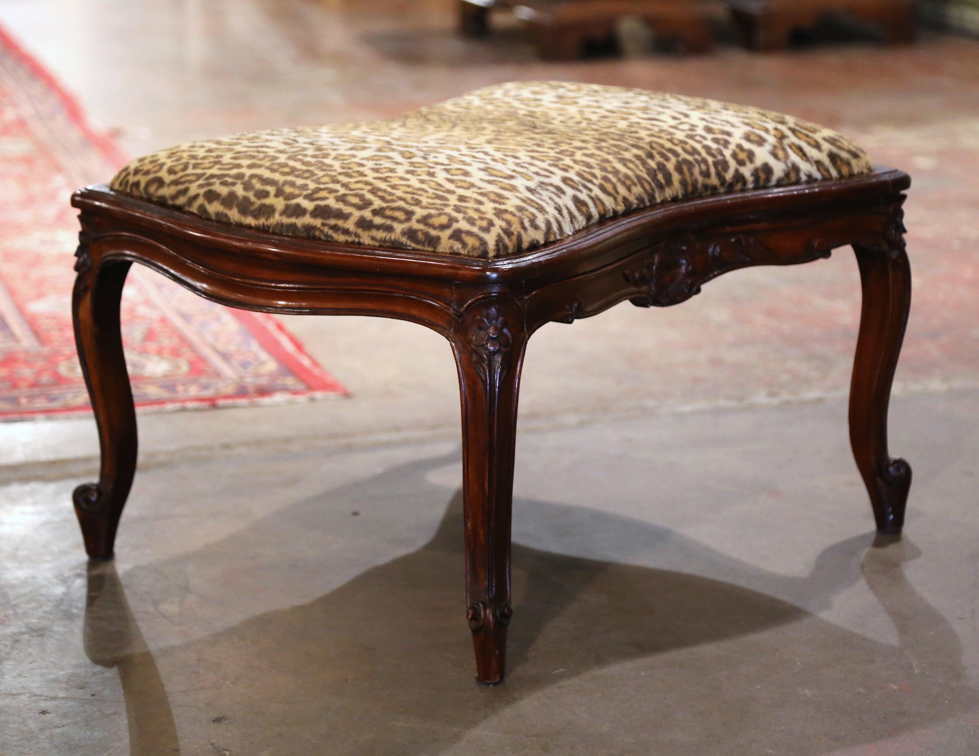 Place this antique stool bench in your den for extra seating. Crafted in Provence, Southern France, circa 1920 and rectangular in shape, the traditional fruit wood seating stands on elegant cabriole legs ending with escargot feet and decorated with