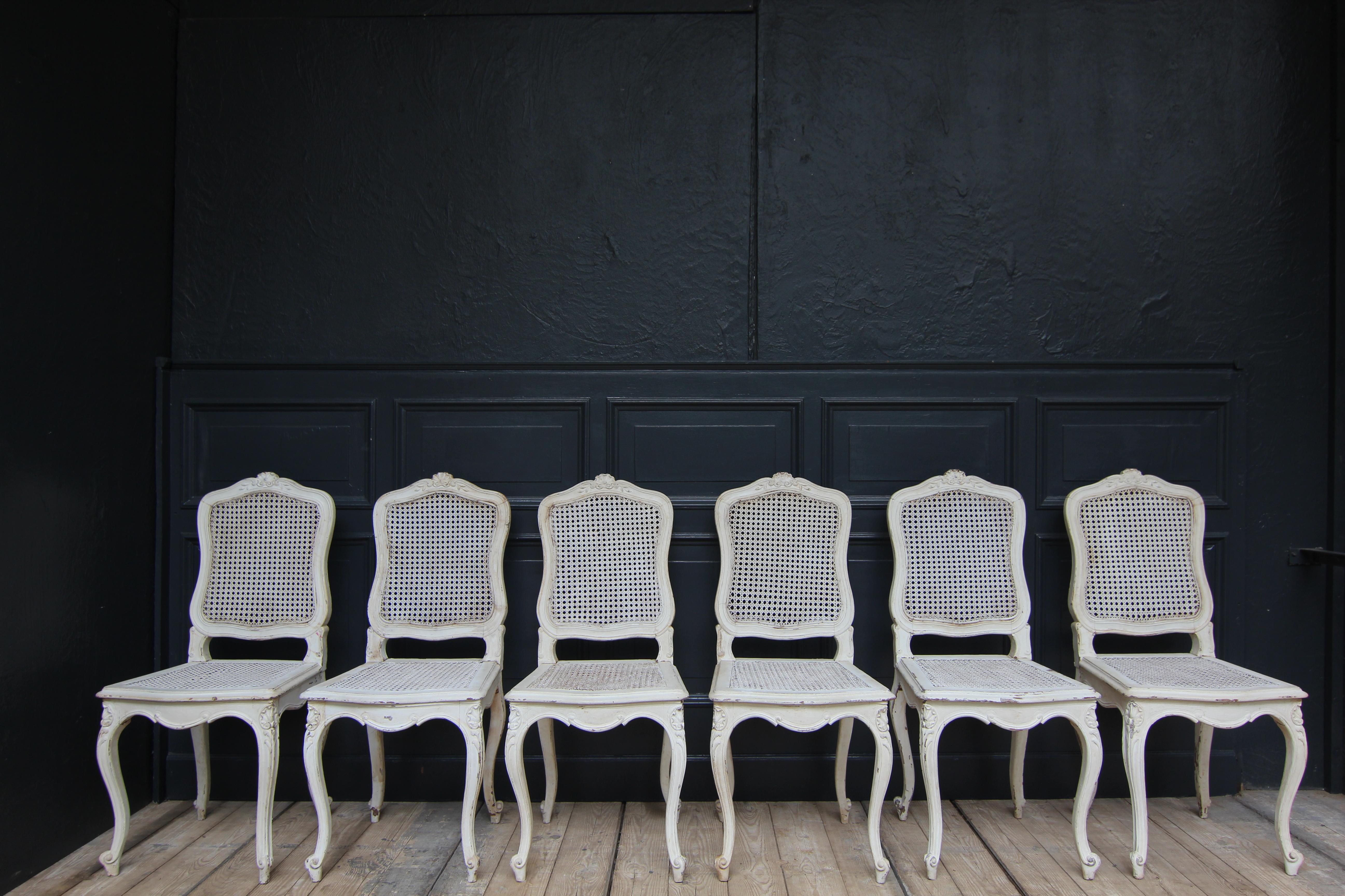 French Louis XV chair group from the early 20th century.

Old white paint with beautiful patina of high decorative value.

Seat and backrest with Viennese wickerwork. The seats are partly somewhat dented, but without cracks.

We would be
