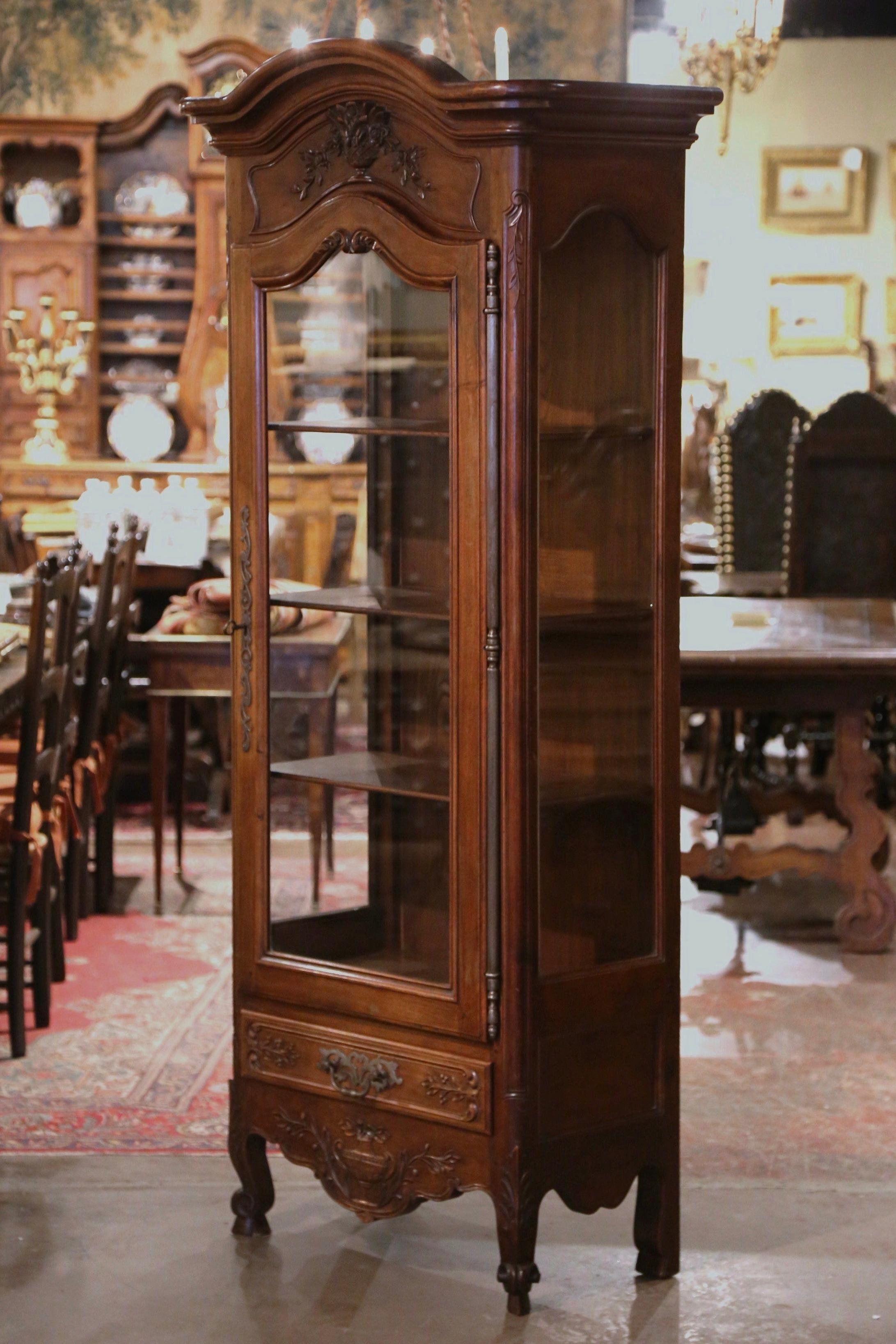 This elegant, antique vitrine was crafted in Provence, France, circa 1920. The fruitwood 