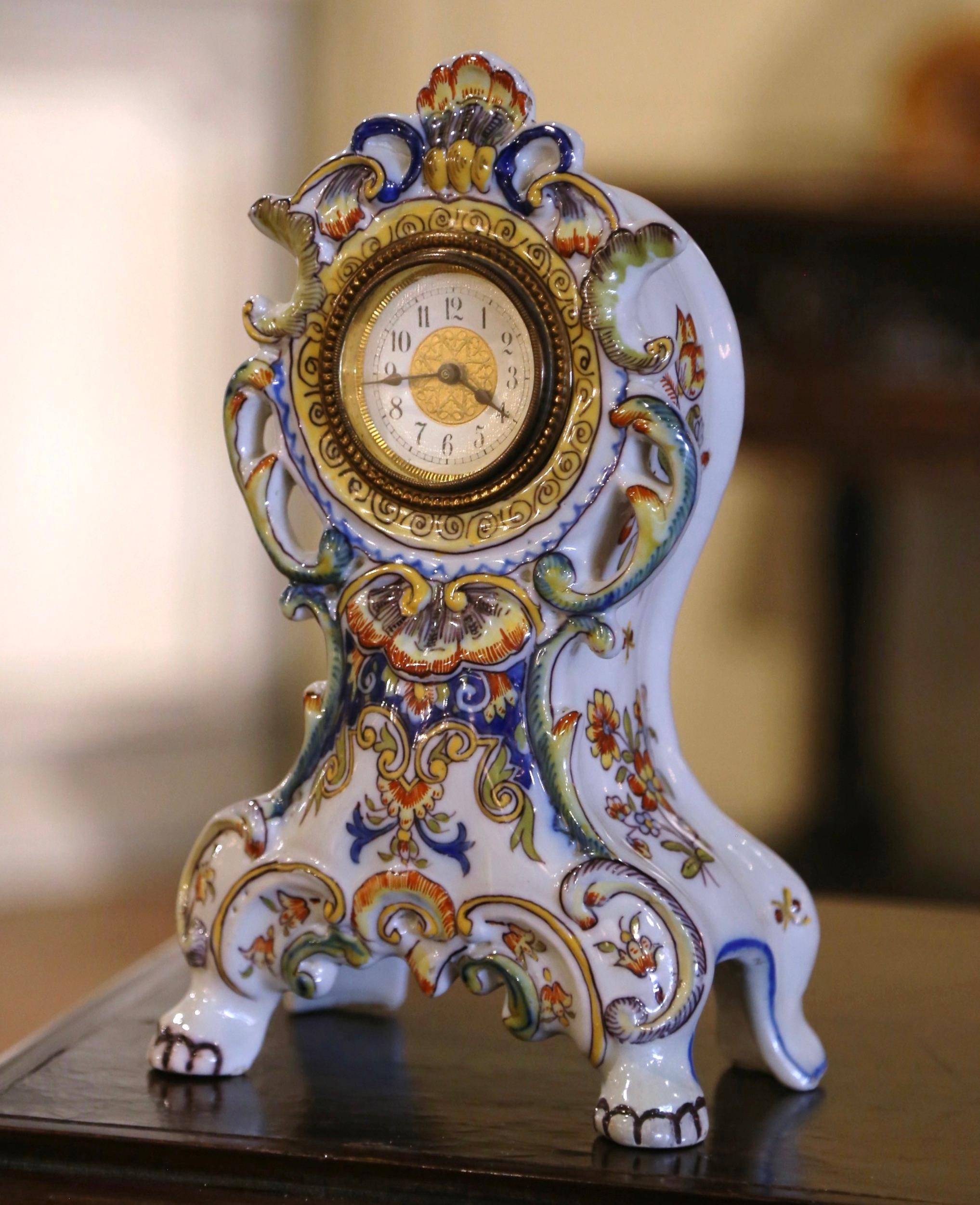 This elegant antique clock would make an wonderful addition to a mantel, console, desk, or side table. Crafted in Rouen, France, circa 1920, the colorful mantel clock features a rich Rococo influence with a prominent shell motif crowning the top.