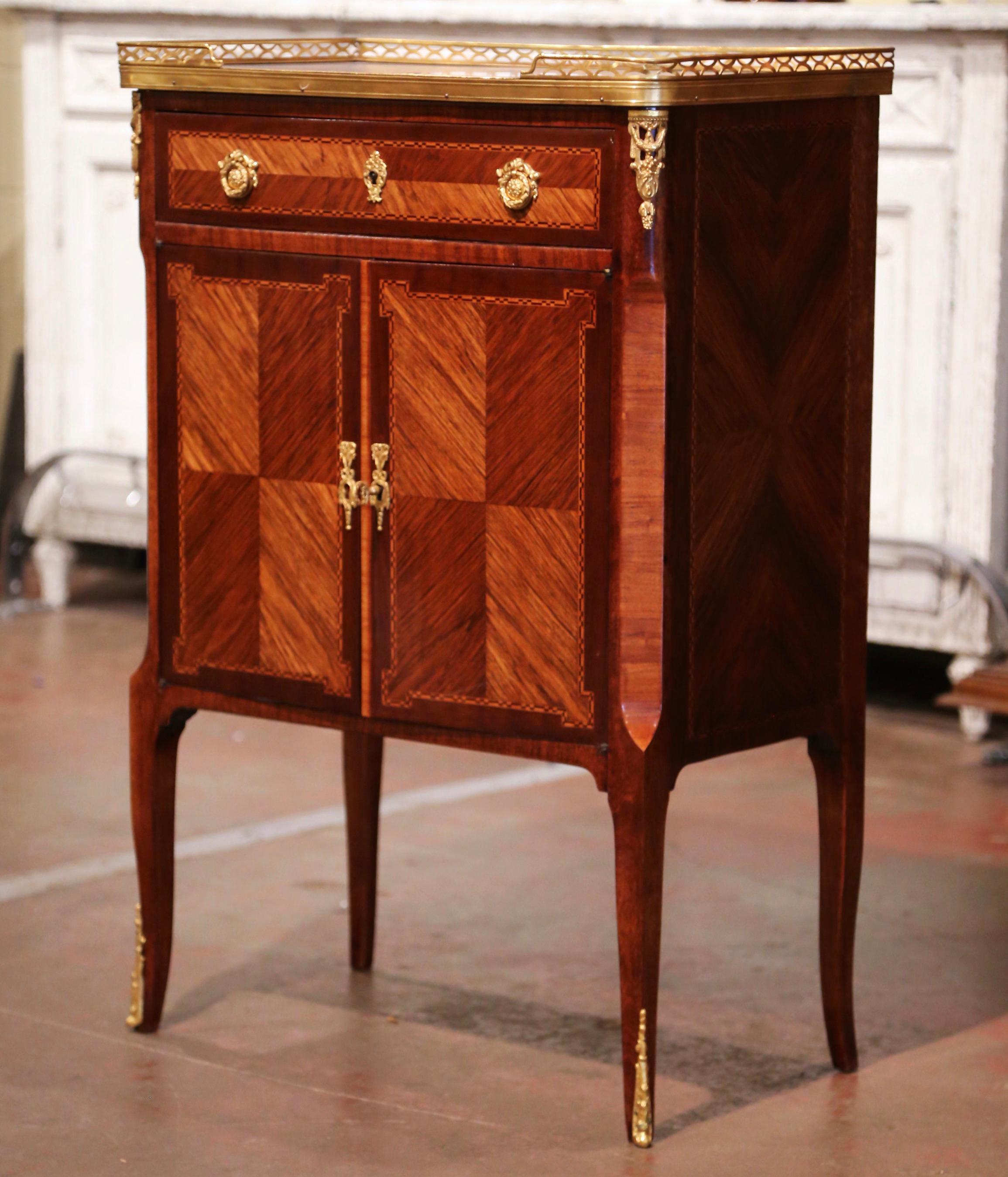 Decorate a living room or bedroom with this elegant antique cabinet. Crafted in Paris, France circa 1920, the fruit wood chest stands on cabriole legs ending with bronze sabots. The cabinet with marquetry and parquetry motifs, features a large