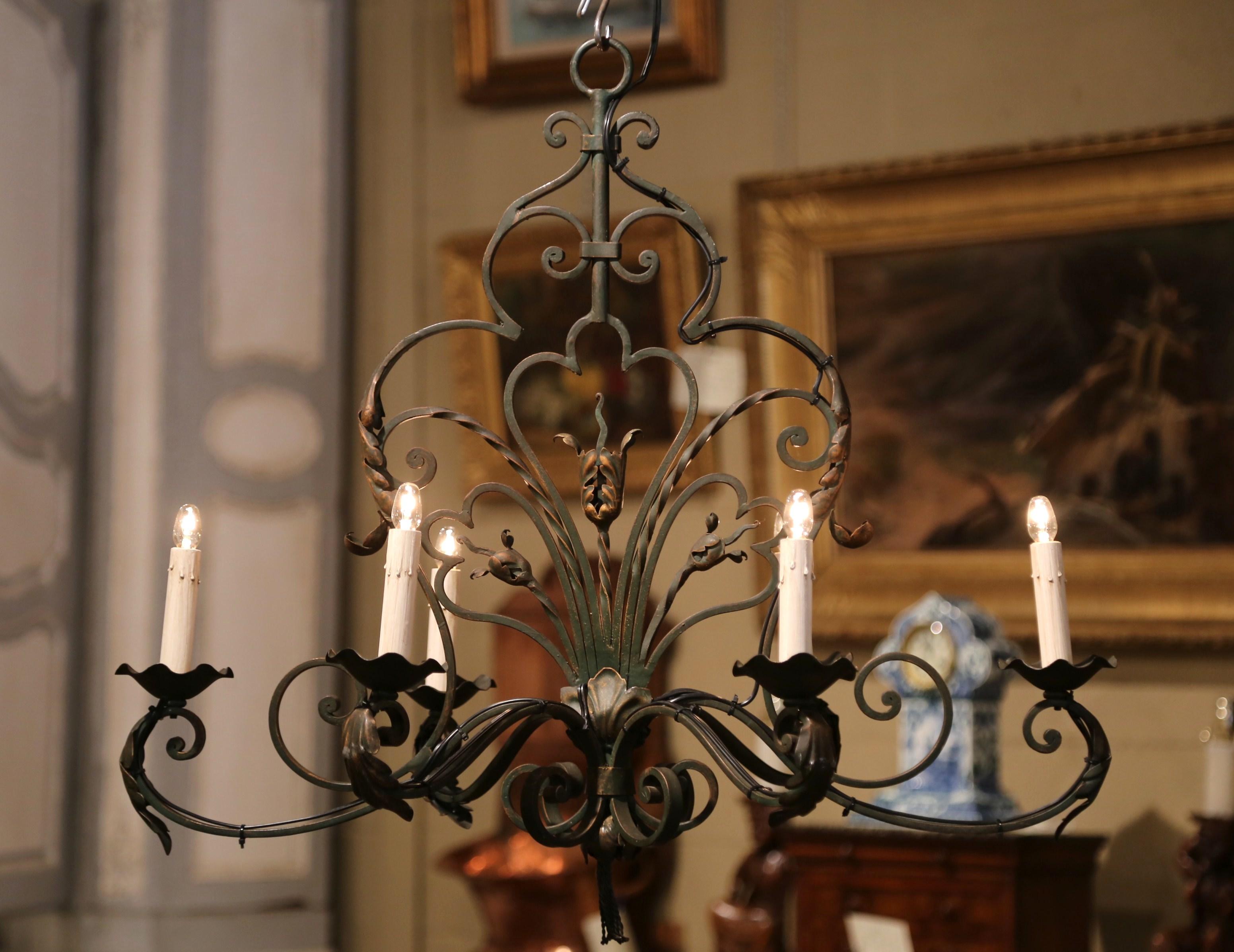 This elegant, scrolling, oblong chandelier would make a lovely addition to a breakfast or dining room. Crafted from iron, the chandelier was made in France, circa 1900. The large chandelier with metal flowers, acanthus leaves and scroll decor,