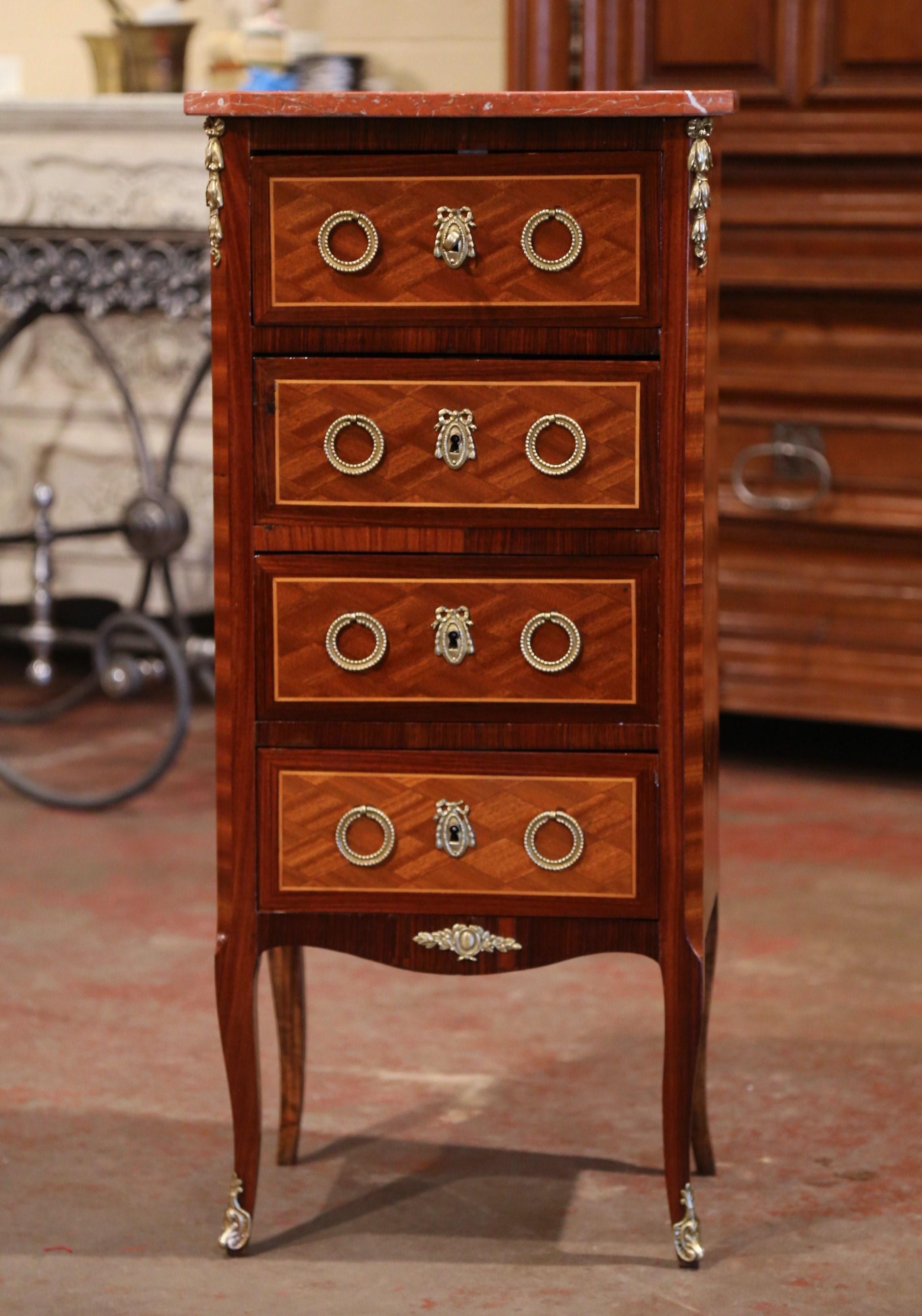 This elegant fruitwood antique commode was crafted in Paris, circa 1920. Versatile, the rectangular petite cabinet could be used as a small storage cabinet in a powder room. The commode sits on cabriole legs with mounts over the feet over a