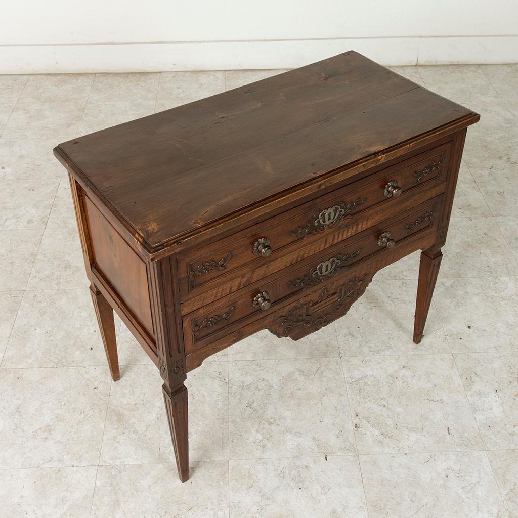 This early 20th century French Louis XVI style ash commode sauteuse or 