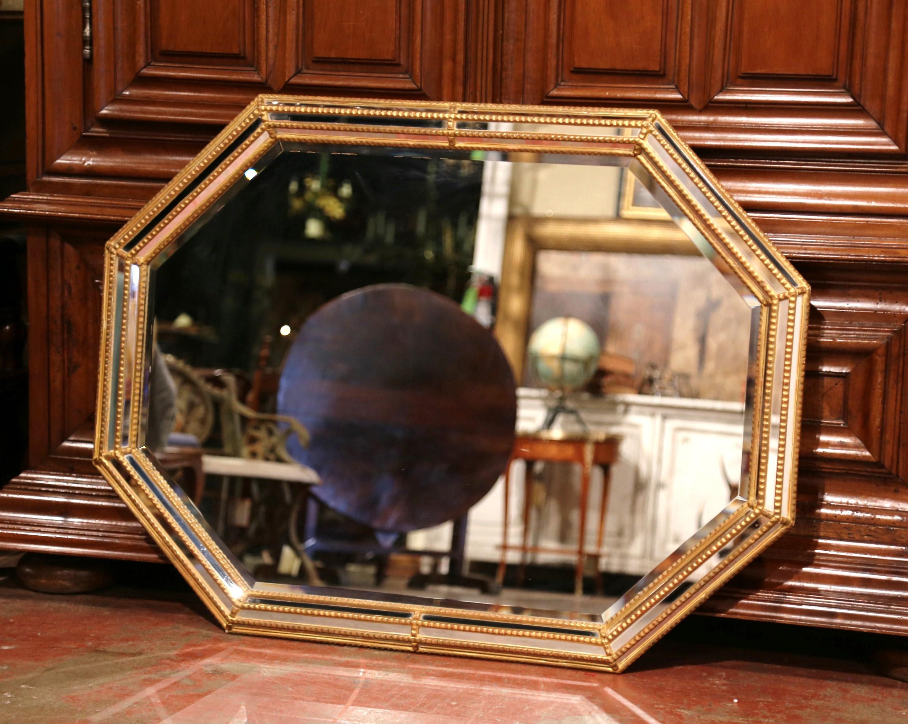 This elegant antique mirror was created in France, circa 1900. Octagonal in shape, the versatile mirror can be hang either horizontally or vertically; it features three rows of small mirror insets around the periphery, and a larger mirror in the