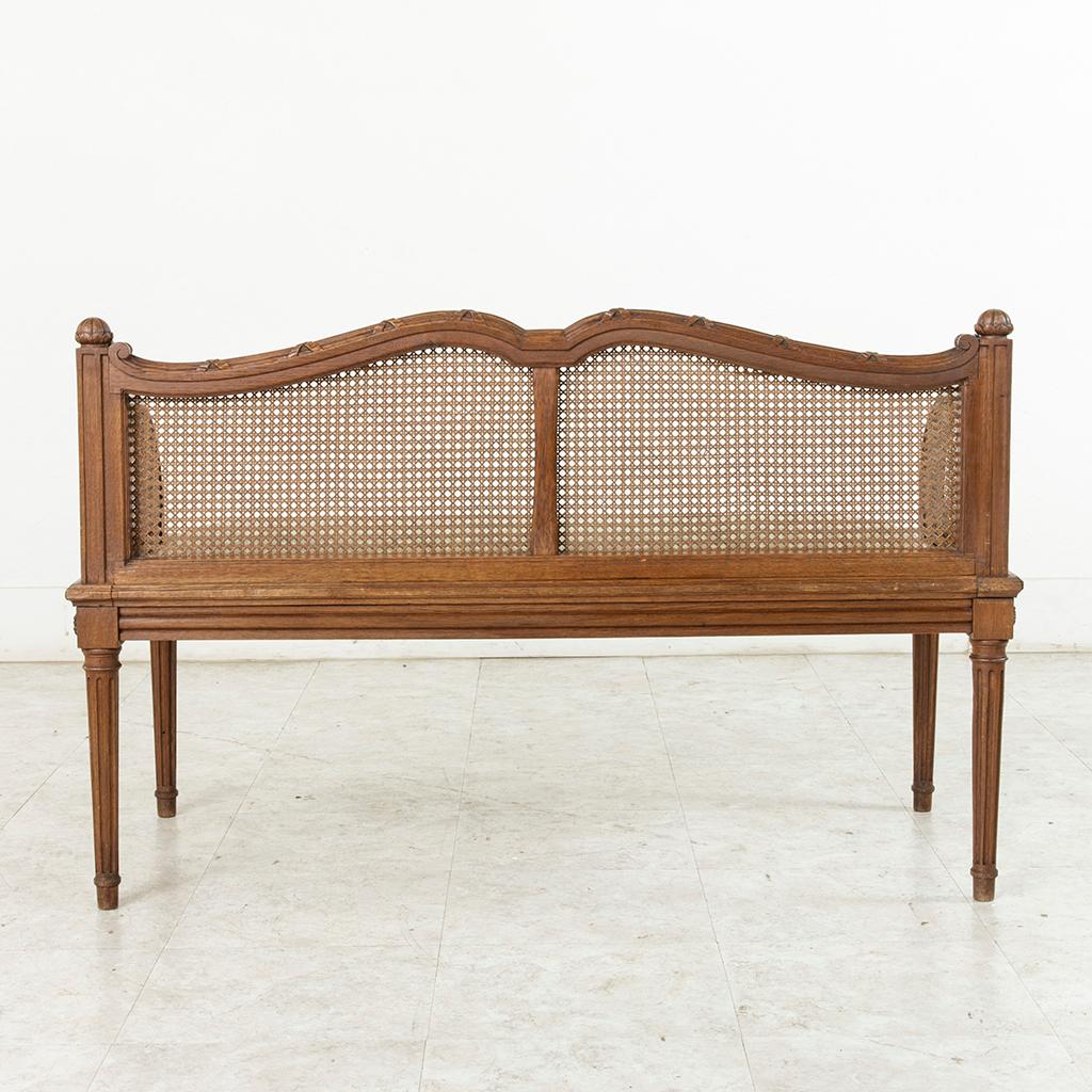 Early 20th Century French Louis XVI Style Carved Oak Banquette Bench with Caning 2