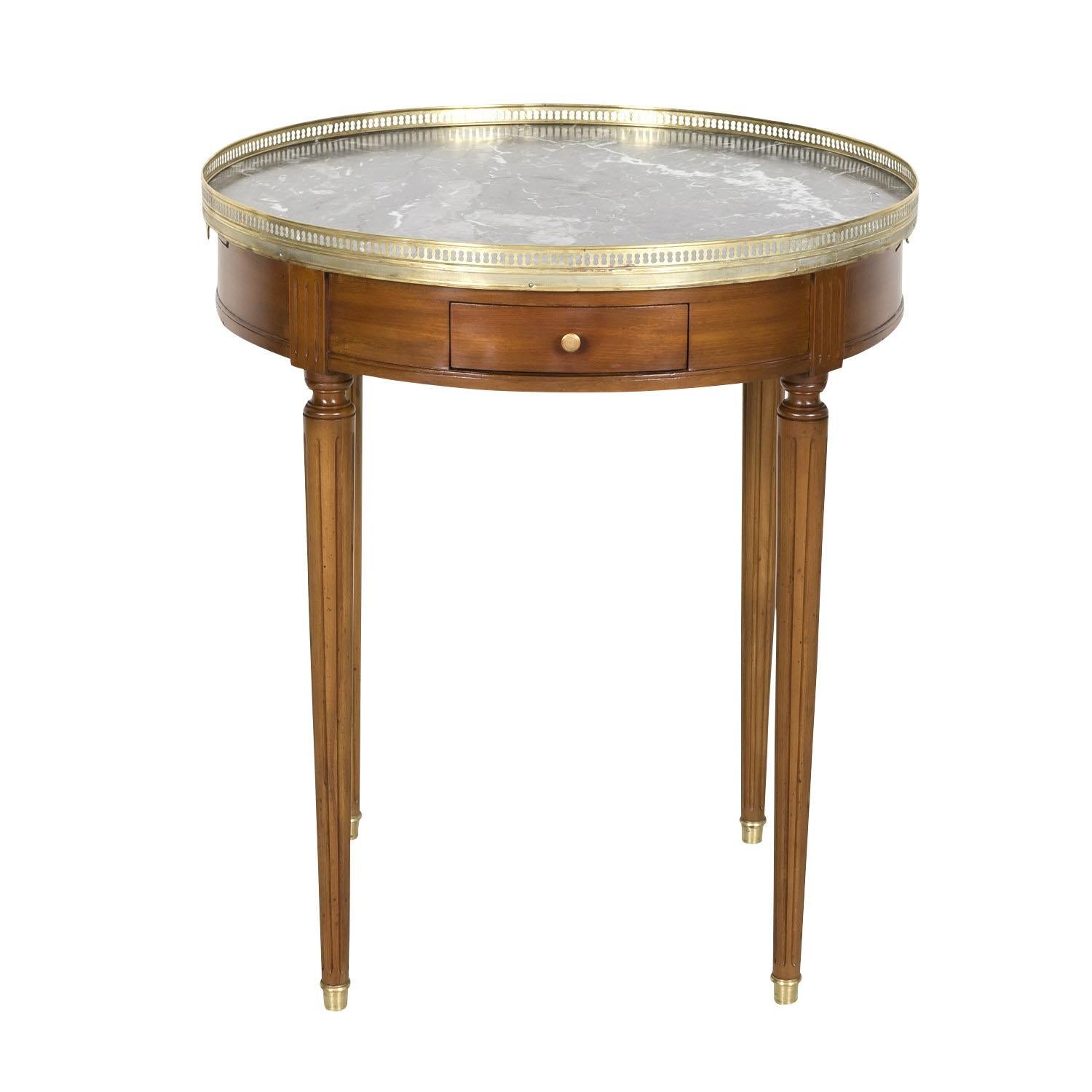 An early 20th century Louis XVI style bouillotte side table handcrafted of mahogany near Bordeaux, circa 1900. Having a Saint Anne gray with white veining marble top surrounded by a pierced gilt brass gallery, this classic French side table features