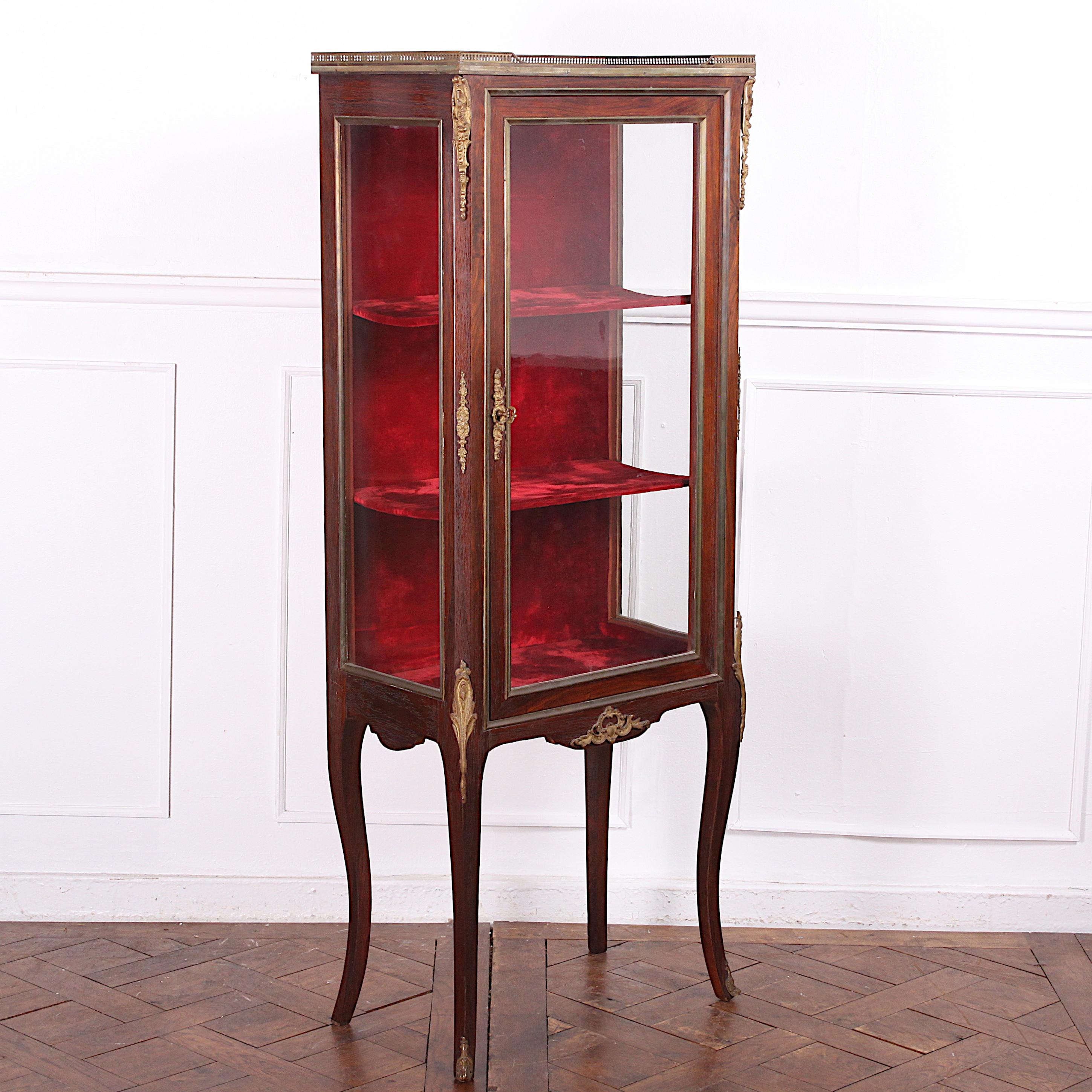 A simple well-proportioned smaller 19th century French mahogany vitrine with original velvet interior in very good original condition. Marble top with pierced brass gallery and ormolu mounts to the case and elegant legs.